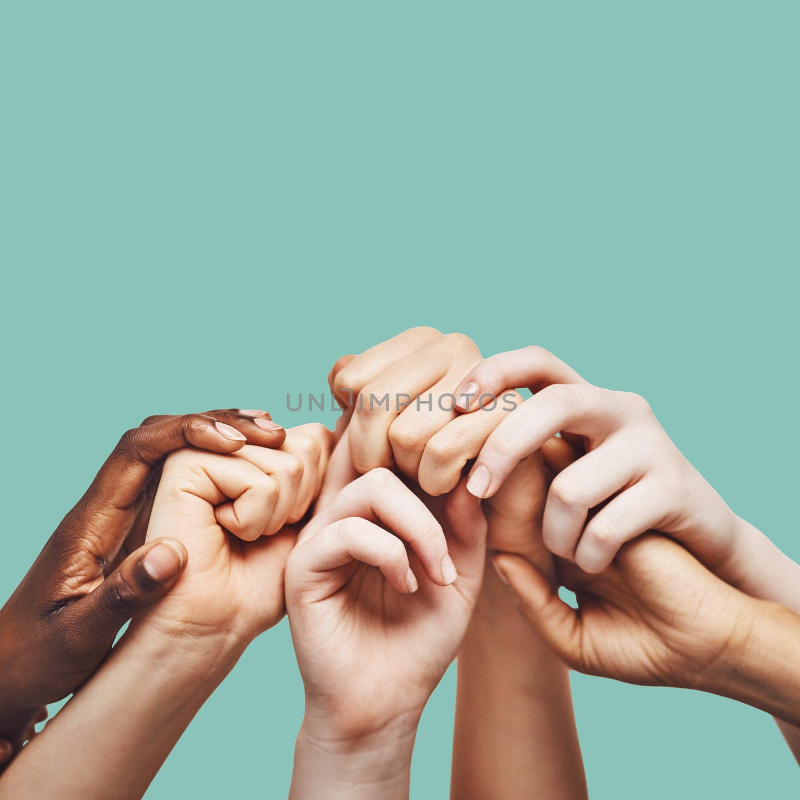 Praying, hands and people united in prayer, worship or community encouragement in studio. Diversity, pray and worship by group in church for praise, help or hope, blessing and God on green background by YuriArcurs