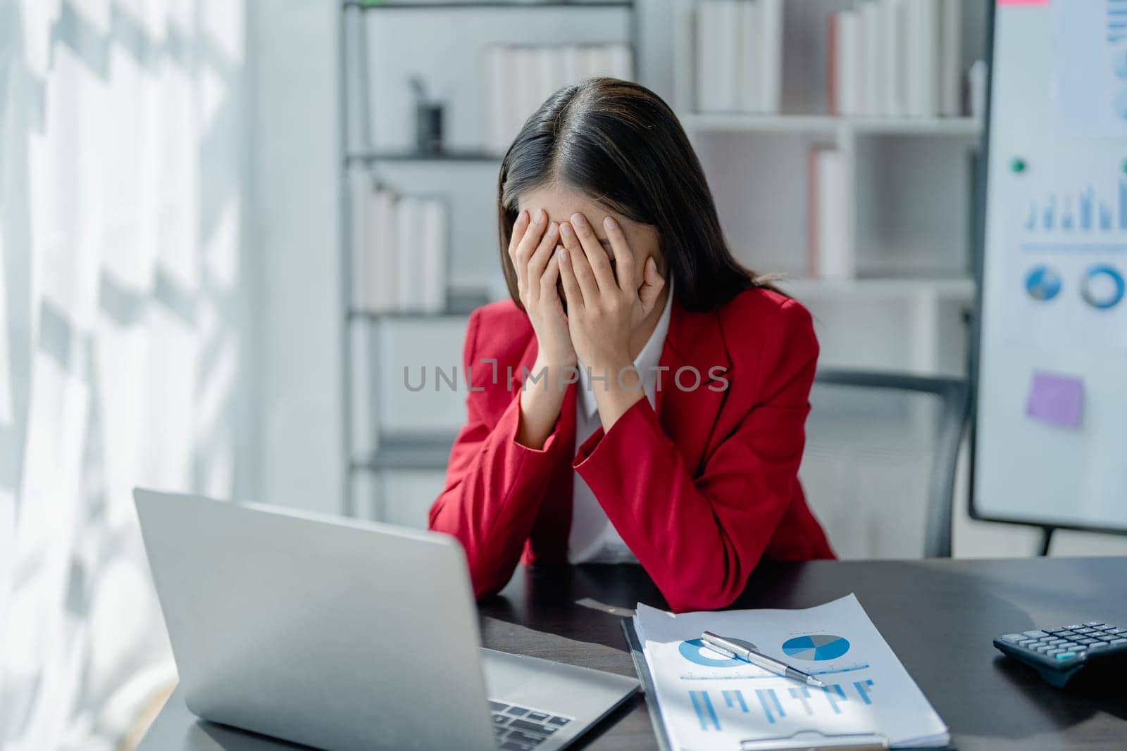 Portrait of business owner, woman using computer and financial statements Anxious expression on expanding the market to increase the ability to invest in business.