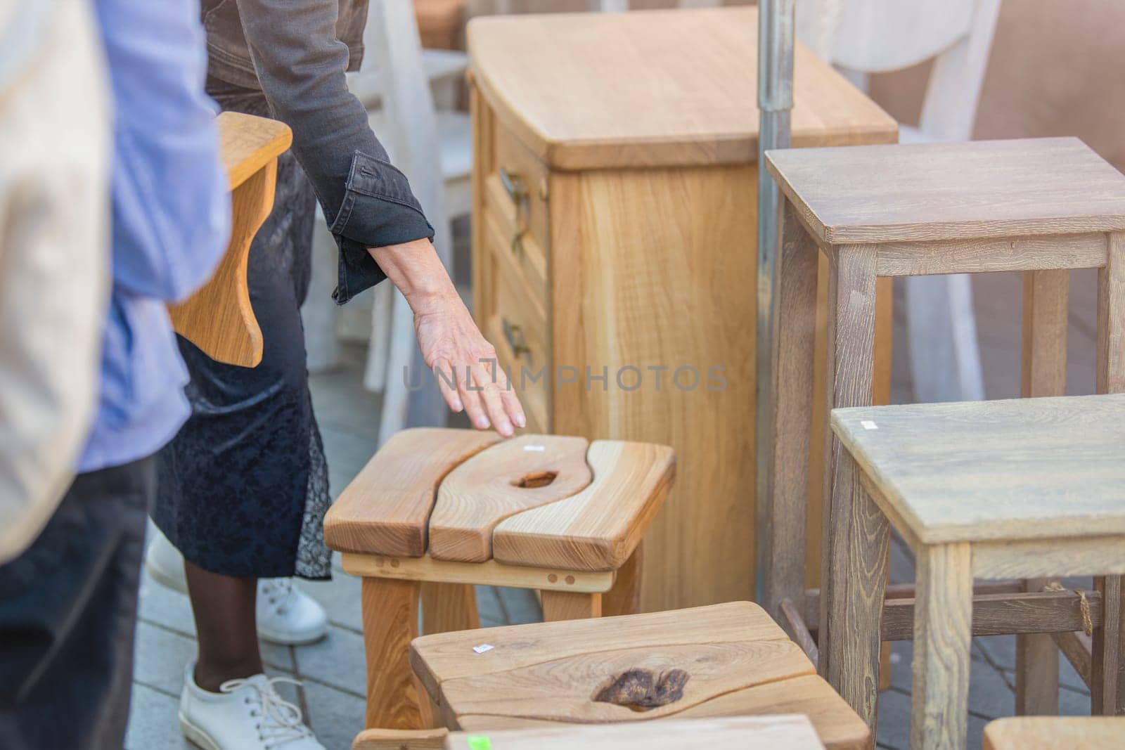 Small business concept. The client chooses a wooden chair. Factory of wooden items. High quality photo