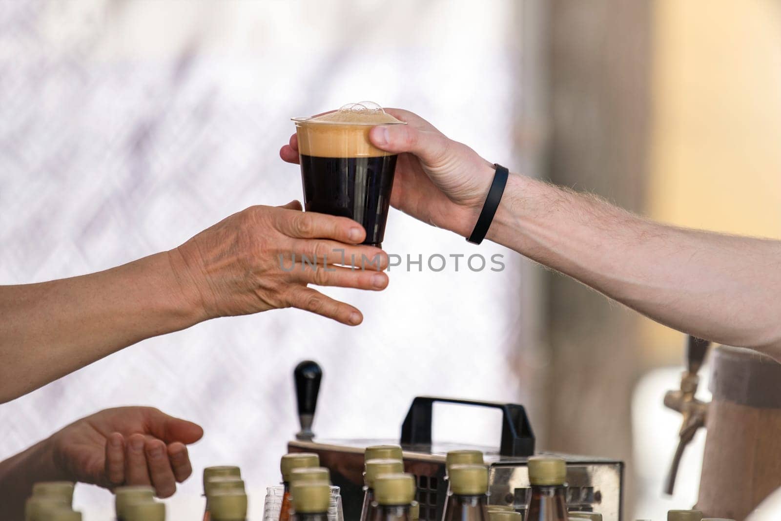 The bartender gives a glass of beer to the customer. The concept of the prohibition or harm of the use of alcoholic beverages