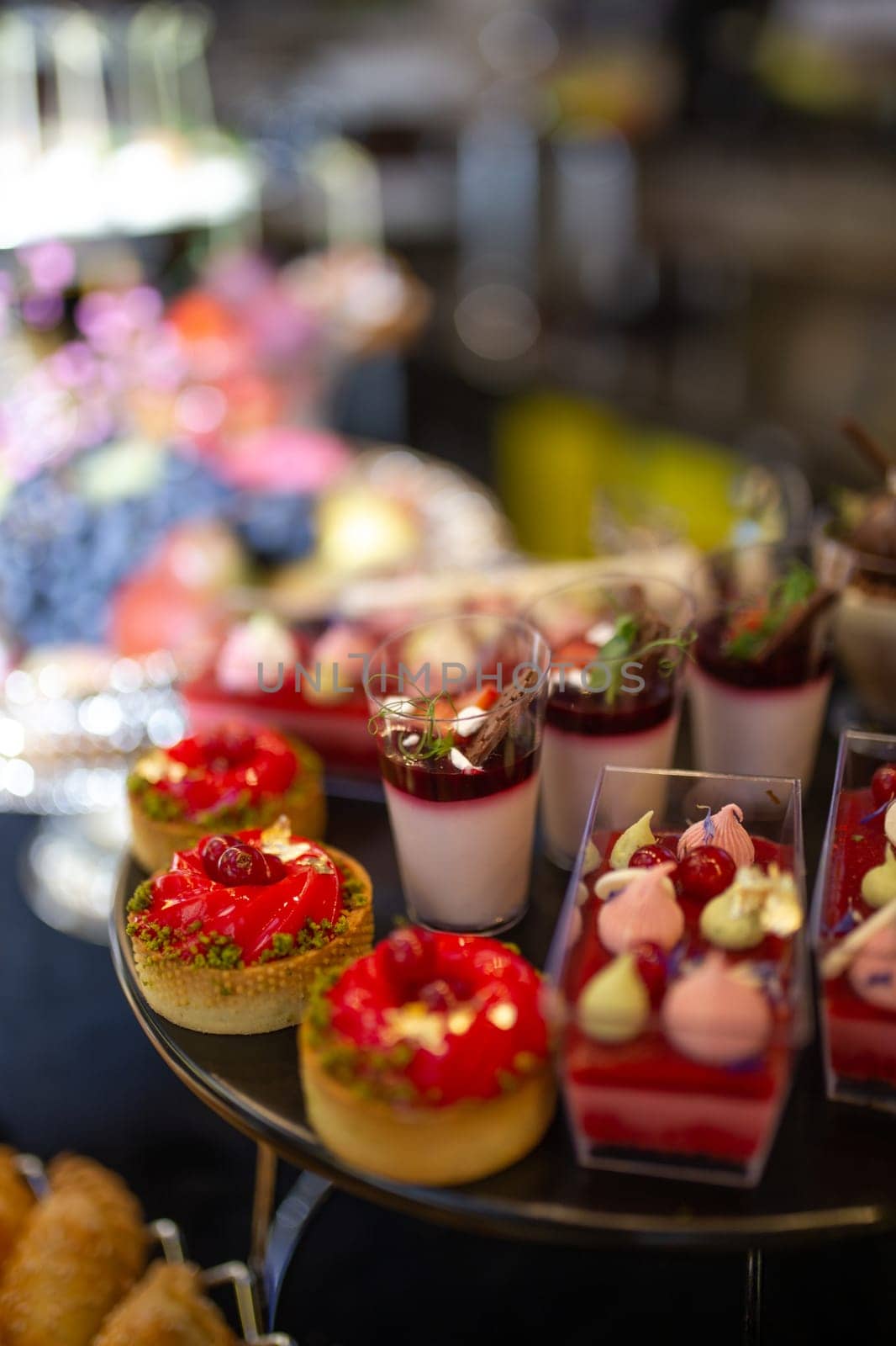 dessert in a plastic basket on the buffet table by Pukhovskiy