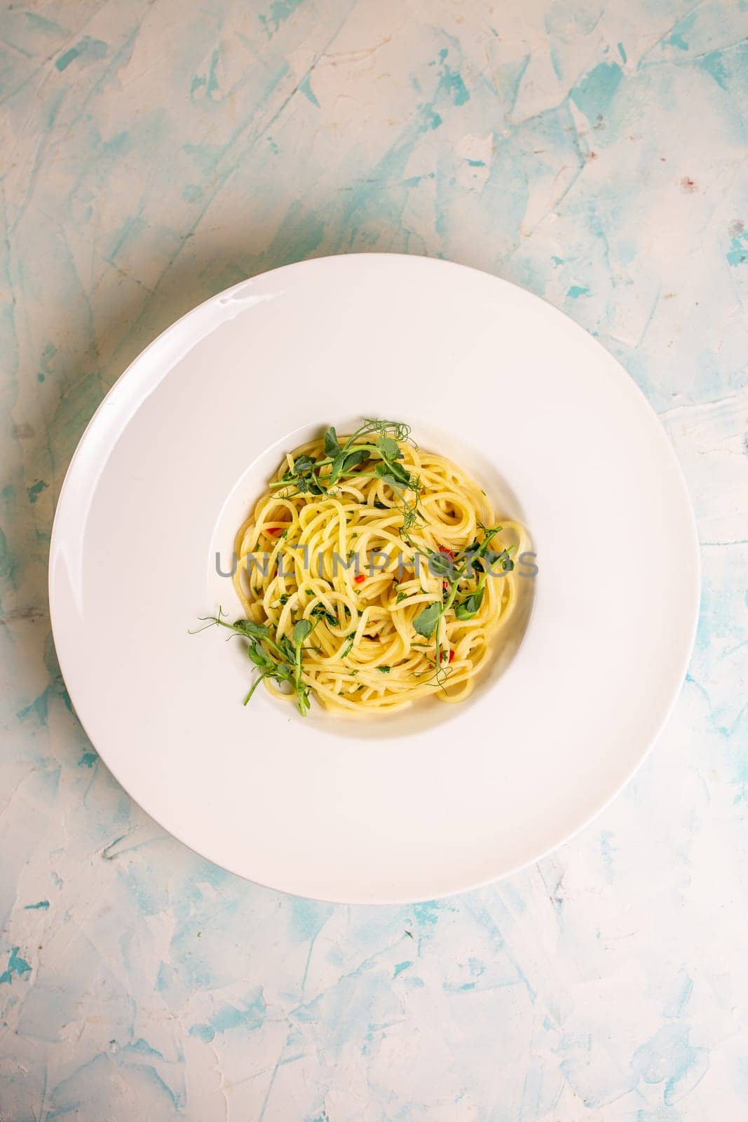 top view of the pasta of hard varieties in a white plate by Pukhovskiy