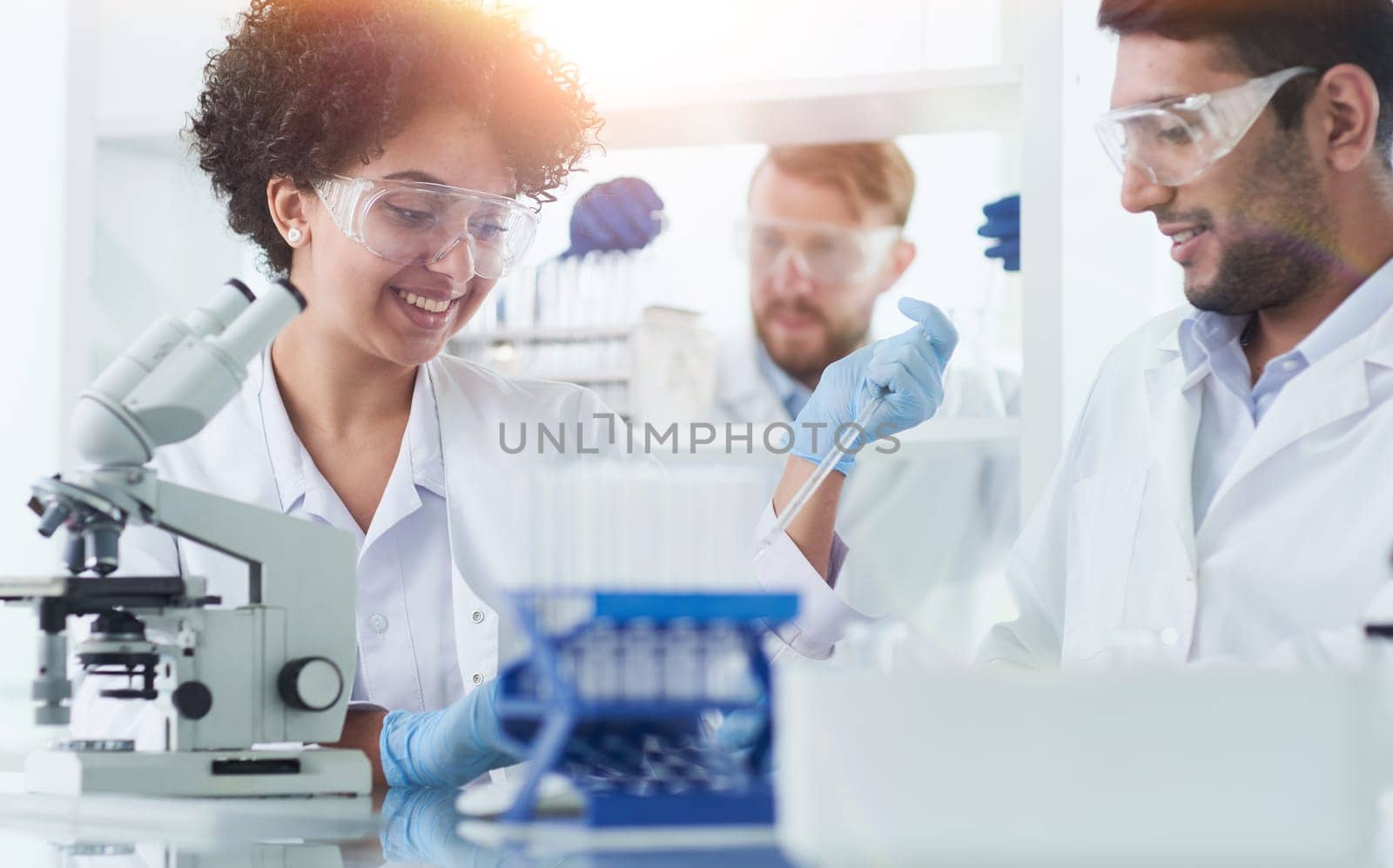 Team of Scientists Working Using Microscope, Analysing Microbiology Samples