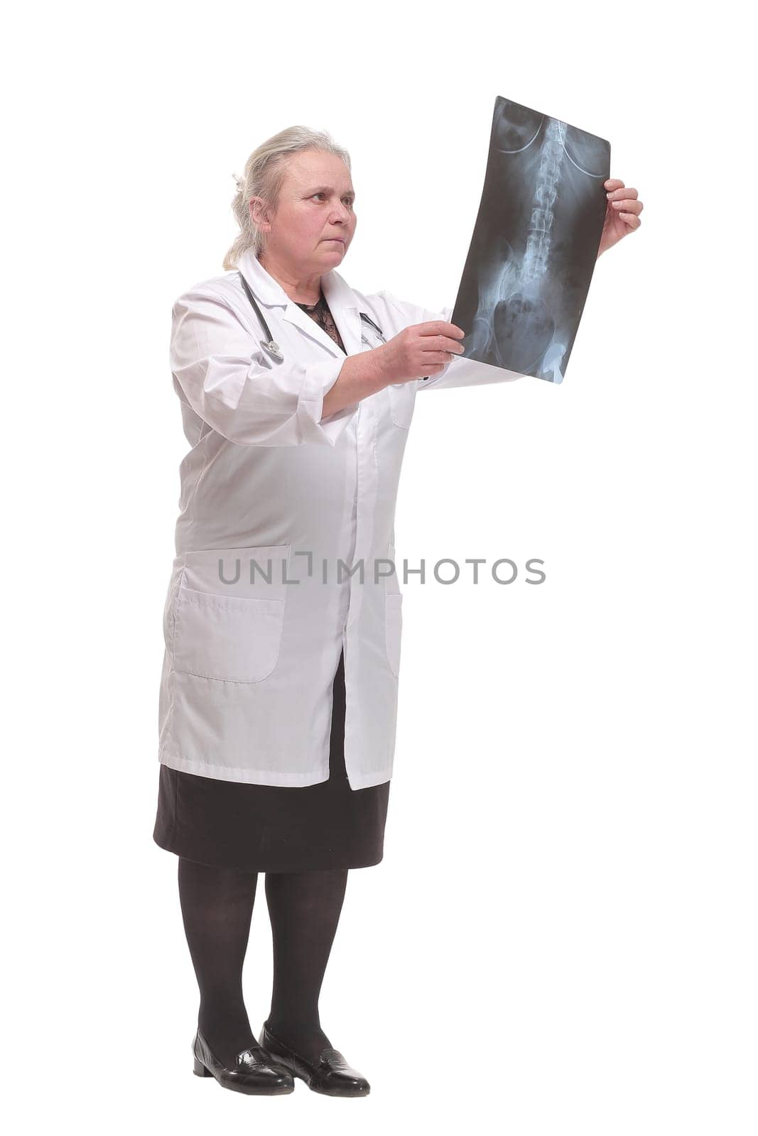 Front view of medical doctor analysing x-ray image looking at camera and smiling