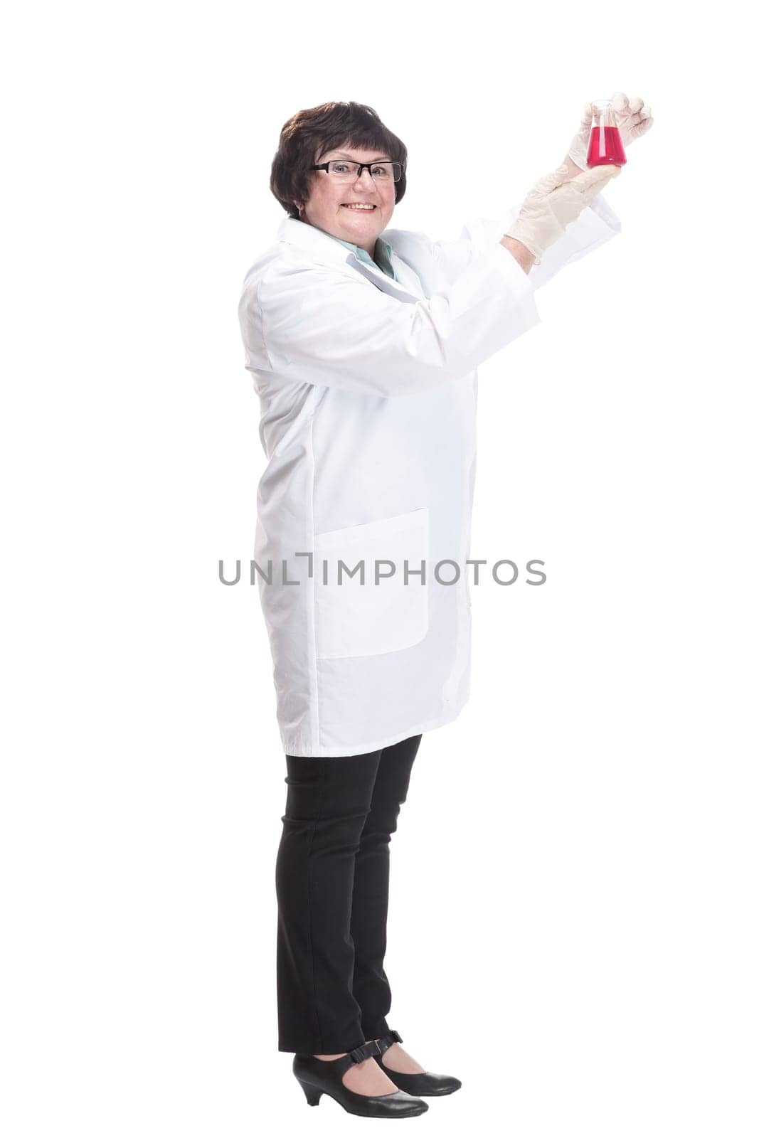in full growth. senior female doctor with a laboratory flask . isolated on a white background.