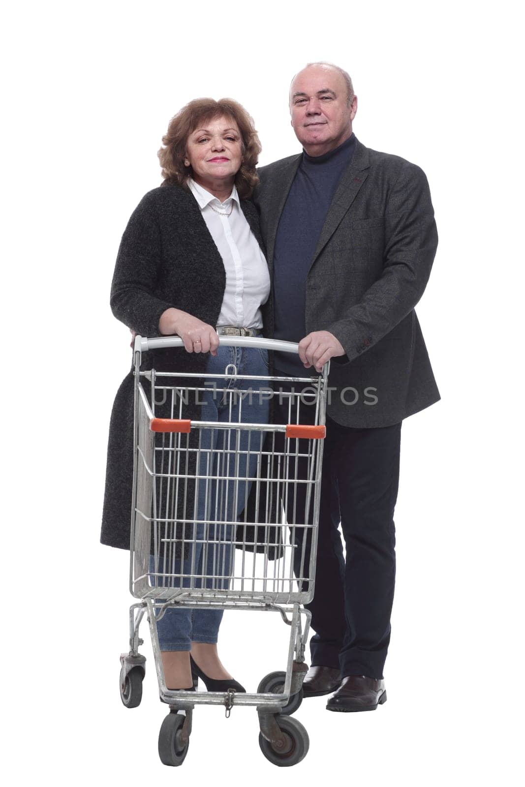 in full growth. elderly couple with a shopping cart . isolated on a white background