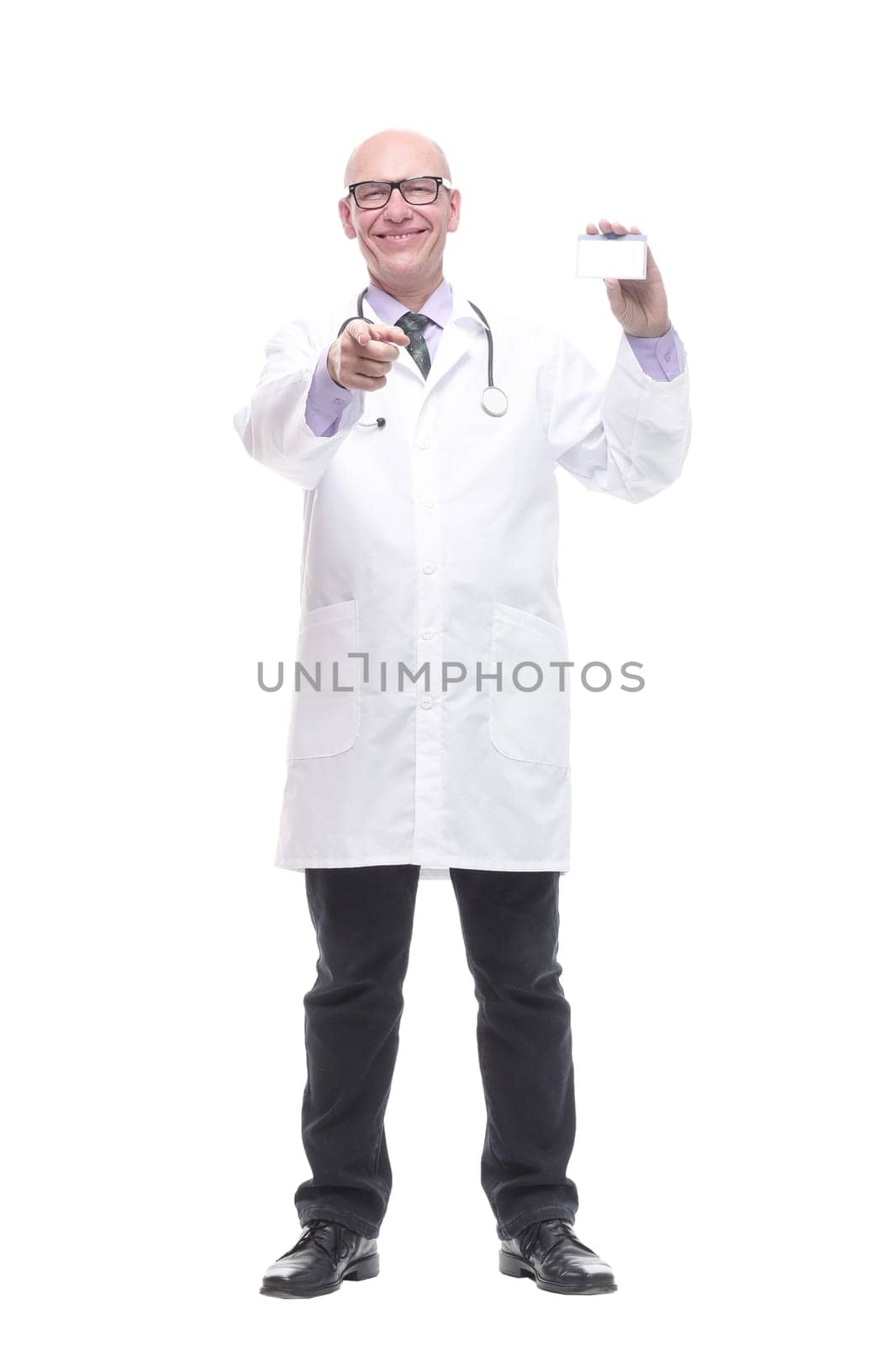 in full growth.smiling doctor showing his business card. isolated on a white background.