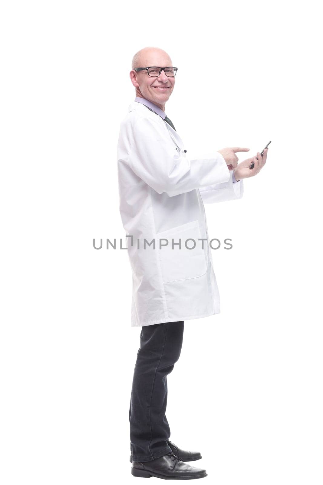 in full growth. doctor with a smartphone. isolated on a white background.