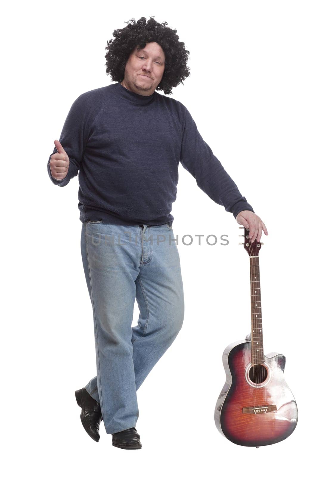 in full growth. curly-haired mature man with a guitar. isolated on a white background.