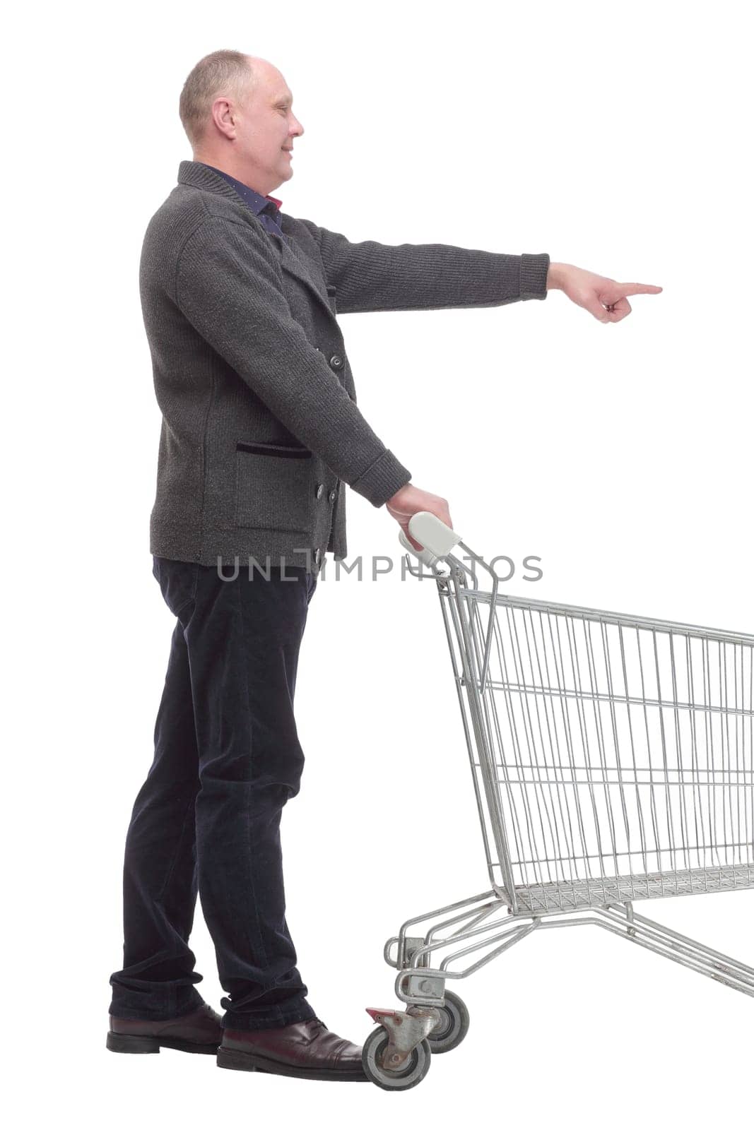 in full growth.smiling casual man with shopping cart .isolated on a white background.