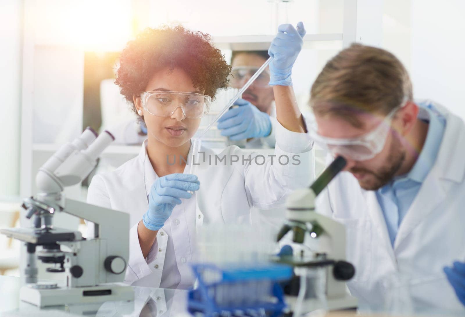 Team of Scientists Working Using Microscope, Analysing Microbiology Samples