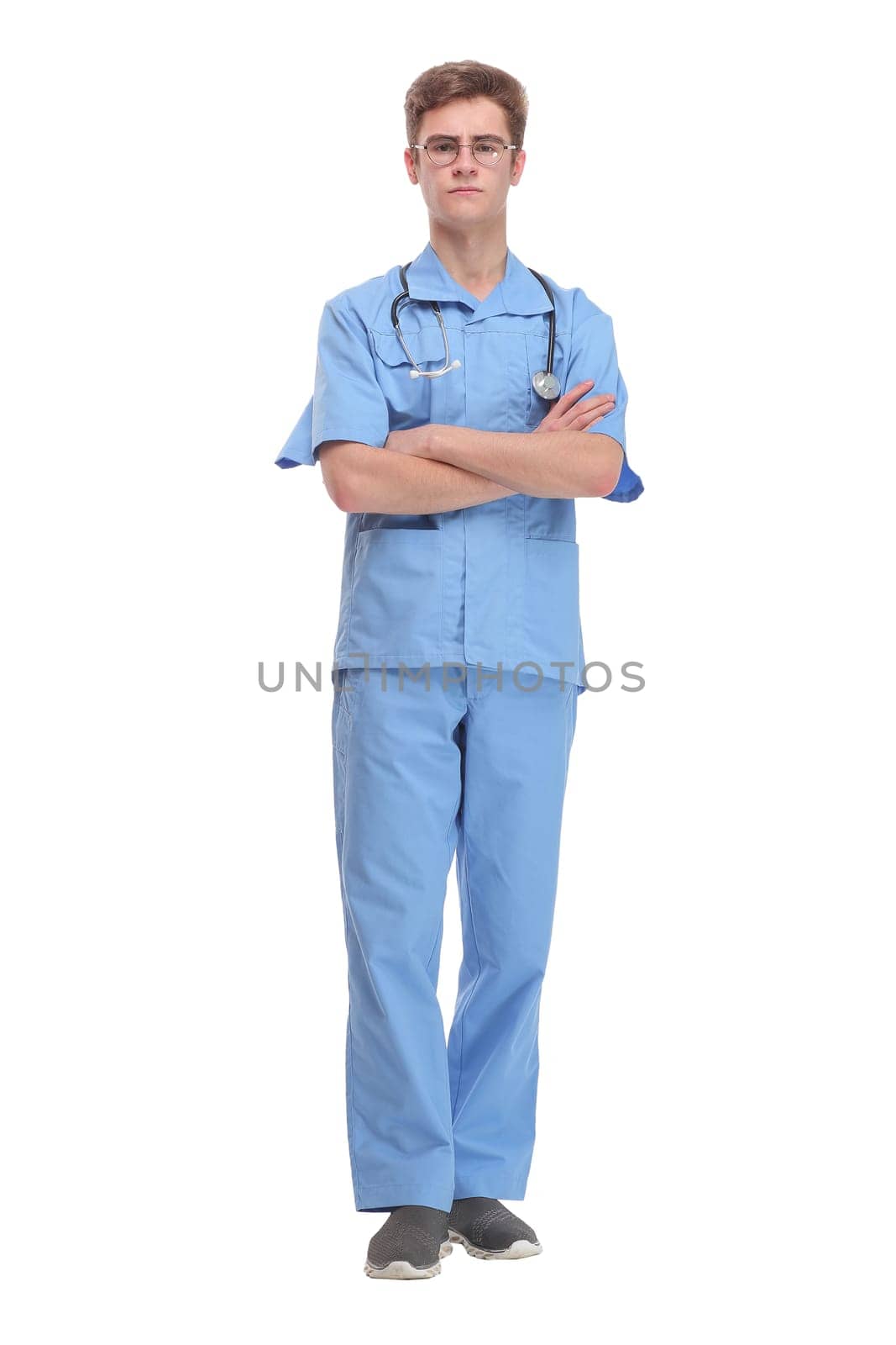 Surgeon wearing blue uniform with stethoscope standing with folded arms isolated on white