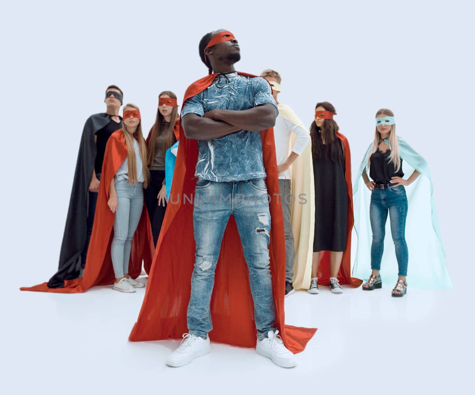 in full growth. stylish guy in a superhero Cape standing in front of his team