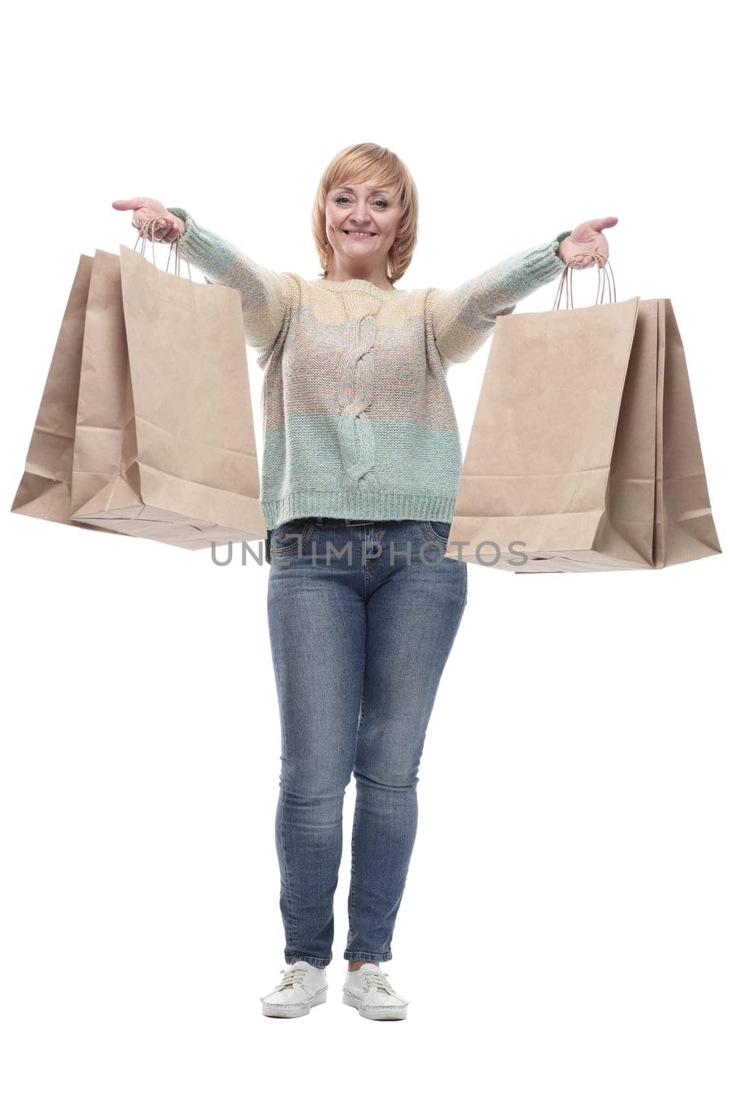 in full growth. attractive casual woman with shopping bags . isolated on a white background.