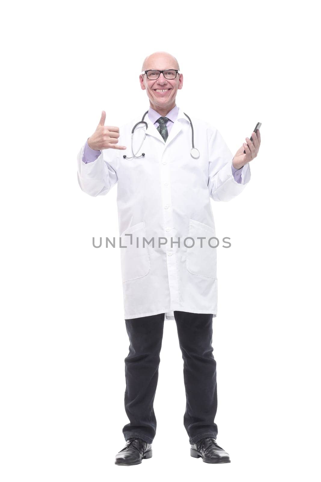 in full growth. smiling doctor with a smartphone. isolated on a white background.