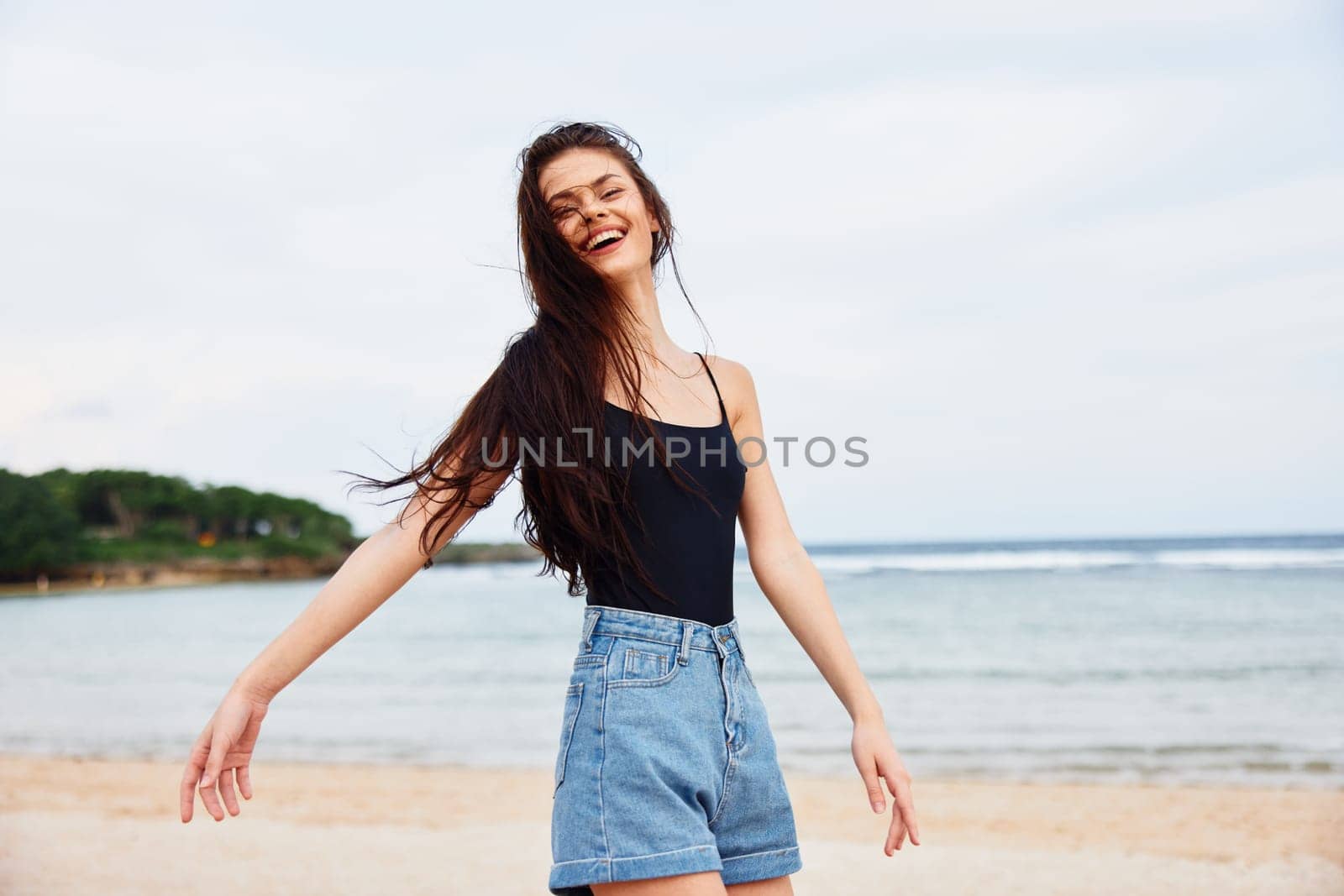 woman wave running smile water sunset happiness positive beach lifestyle sea fun tan sunrise walking carefree beautiful young travel hair summer