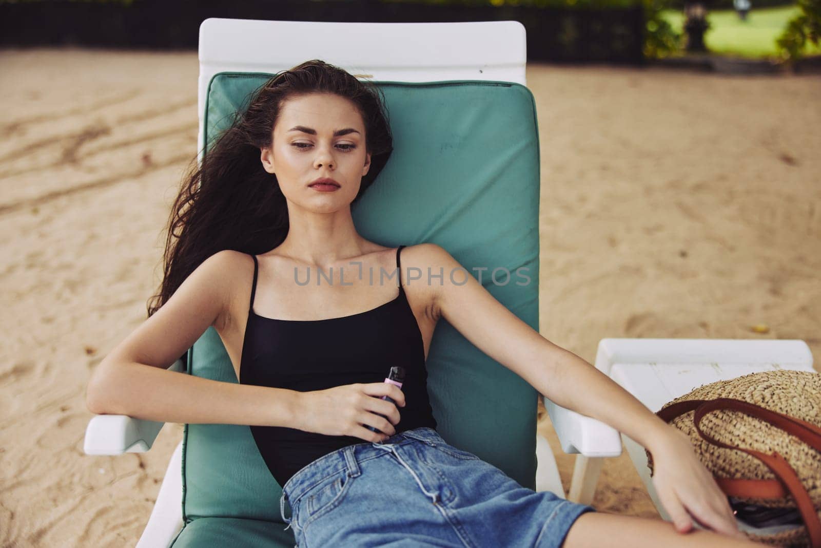 ocean woman travel chair lifestyle sitting long female beautiful resort beach enjoy sea girl hair sand chair sunbed smiling beach holiday caucasian lying