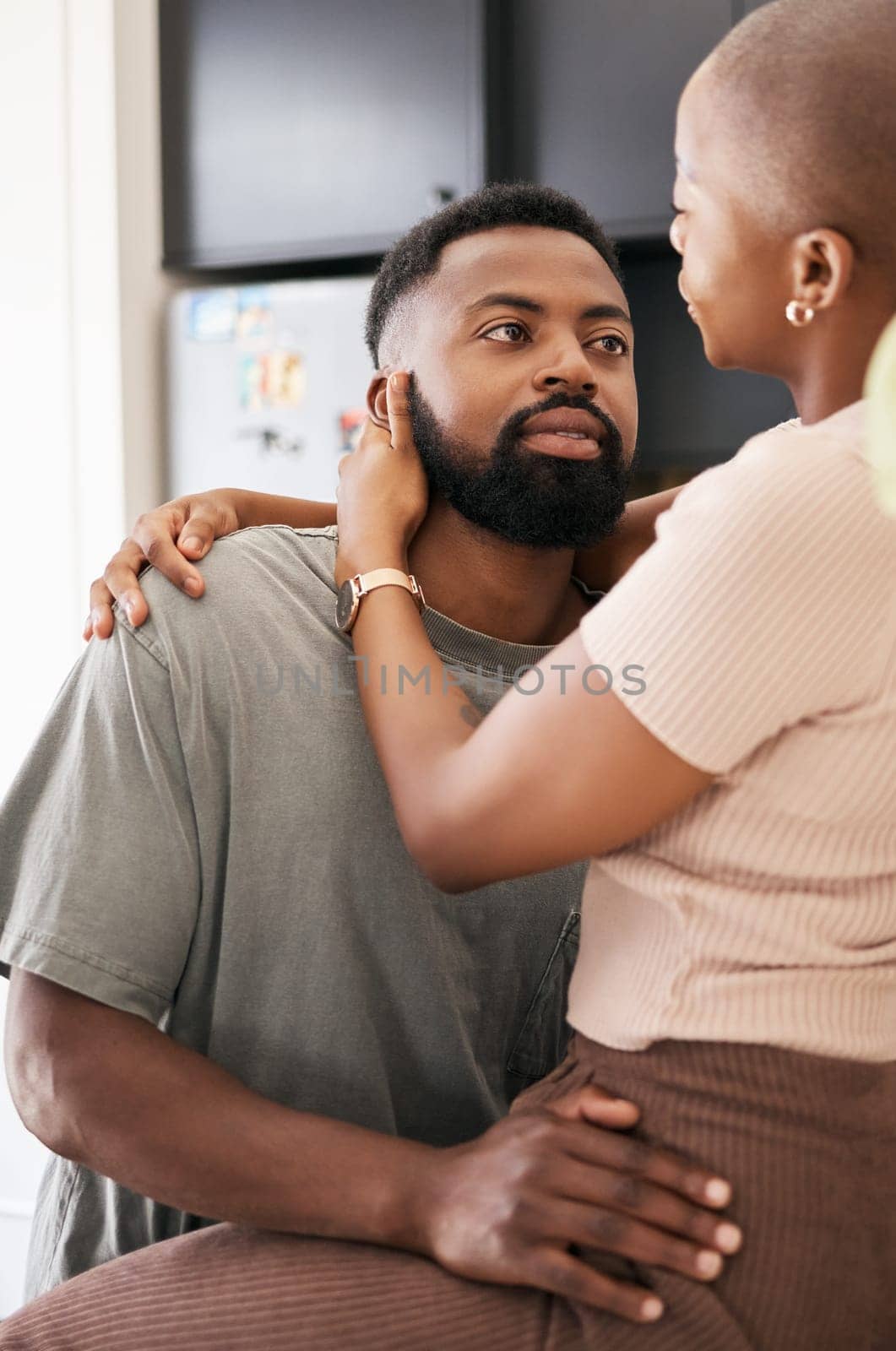 Kitchen, love and black couple hugging in their home with care, support and comfort in the morning. Intimacy, affection and young African man and woman embracing with romance in their modern house