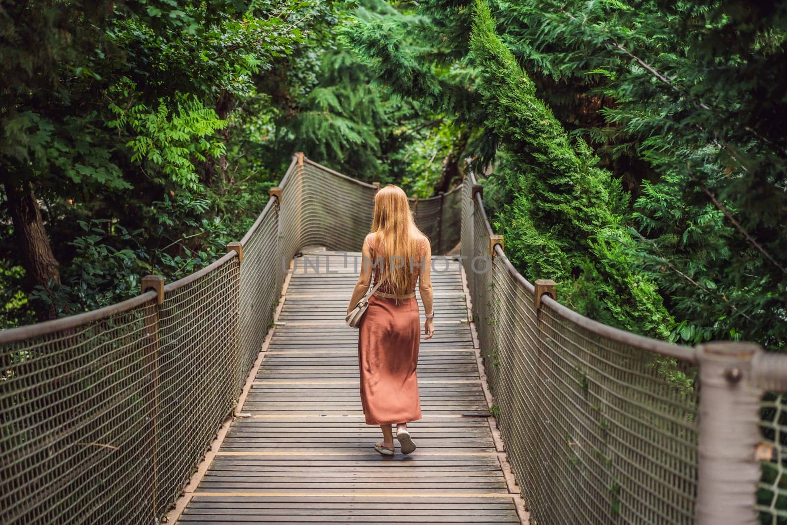 Woman tourist in Rope bridge in Yildiz Park. Besiktas, Istanbul, Turkey. Turkiye.