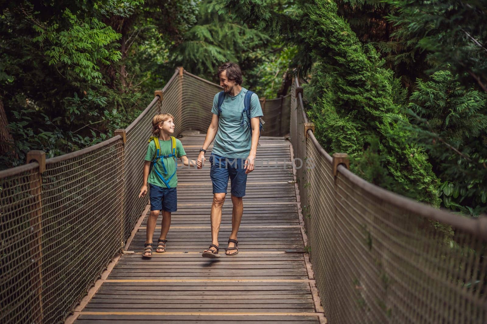 father and son tourists in Rope bridge in Yildiz Park. Besiktas, Istanbul, Turkey. Turkiye. Traveling with kids concept.