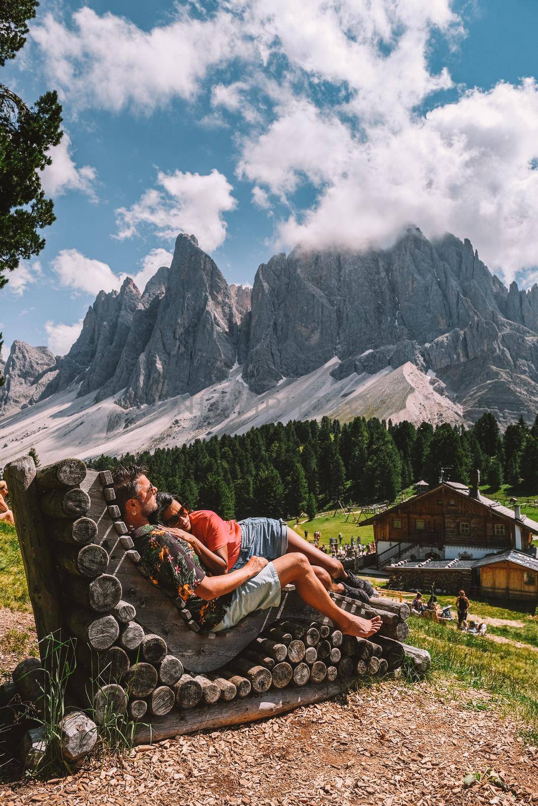 couple on vacation in the Italian Dolomites, View of the Geisler, Dolomites Val Di Funes Zanser Alm. Italy