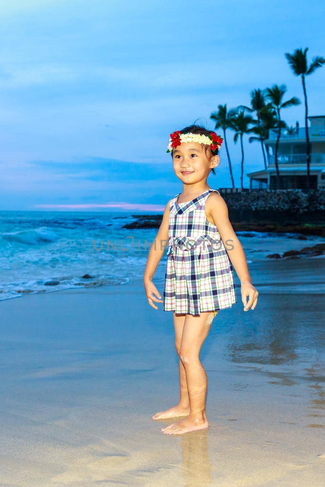 Adorable girl enjoys play time on the beach.
