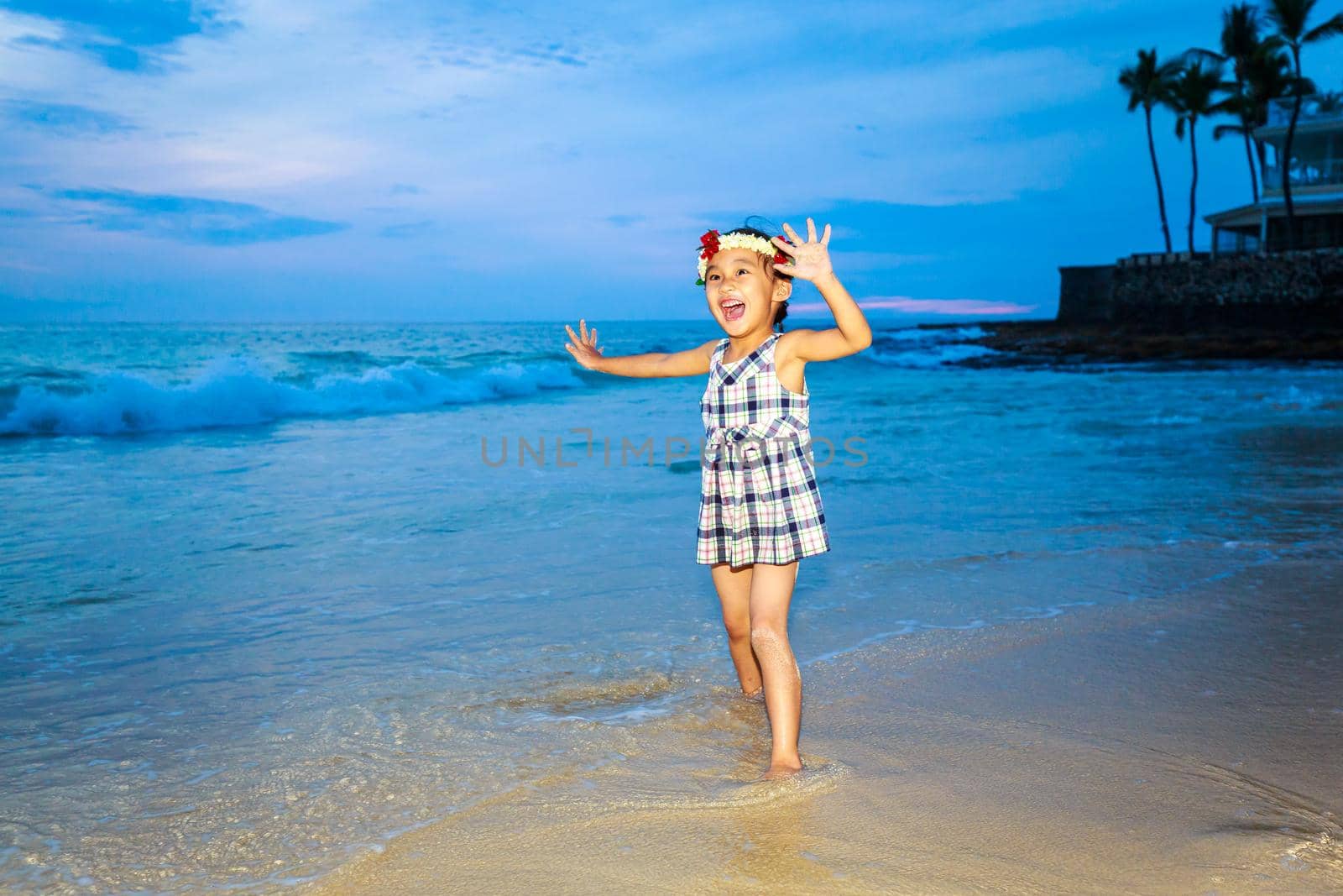 Adorable girl enjoys play time on the beach.