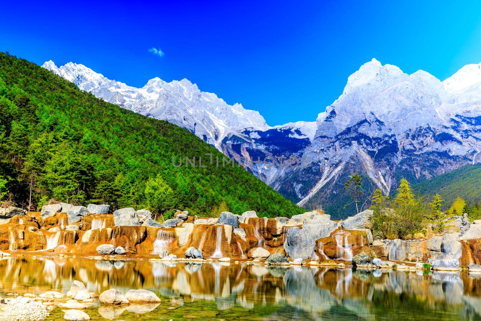 A view of a river and Jade Dragon Snow Mountain in Lijiang (Southwest China).