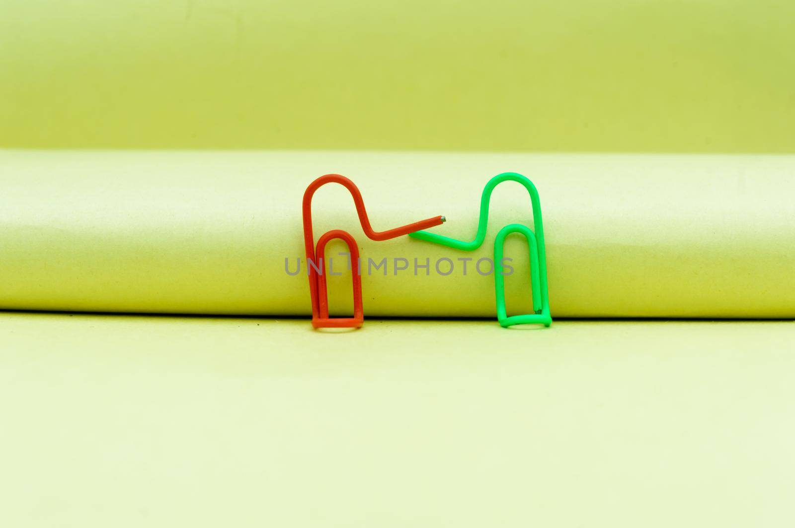 Two businessmen shaking hands. Abstract Human Figure of Paper Clip. Creative Photography. Still Life. Copy Space