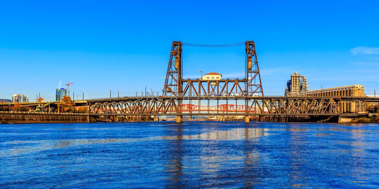 A wide angle view of the steel bridge crossing the Willamette river in Portland, Oregon.