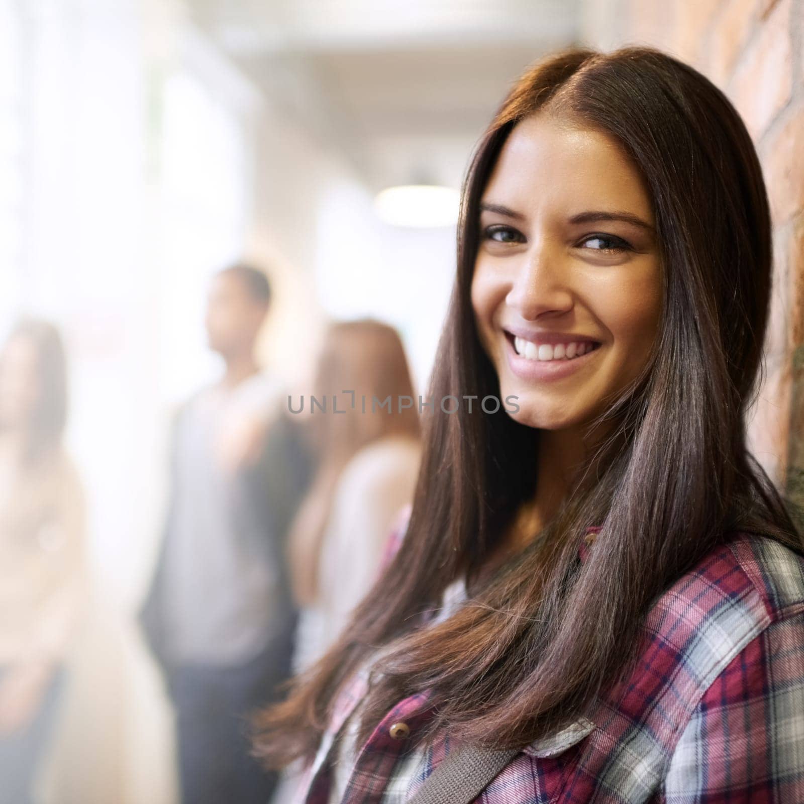 Being on campus is such a pleasure. Portrait of a beautiful young female student leaning against a brick wall