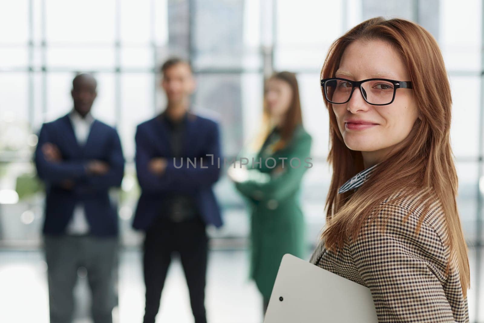 business woman holding notepad during presentation in conference room