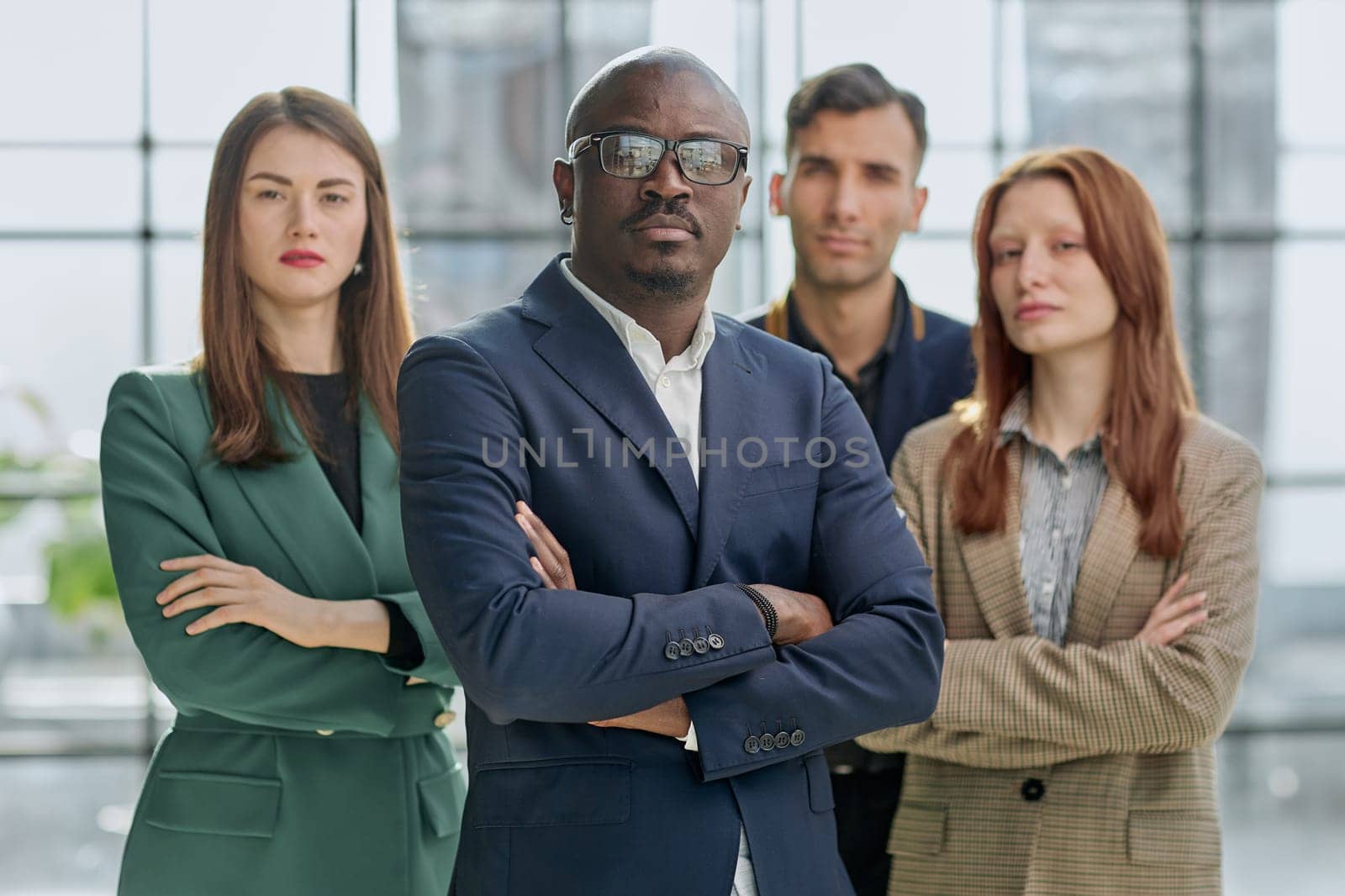 a team of businessmen stand in the lobby of a modern office