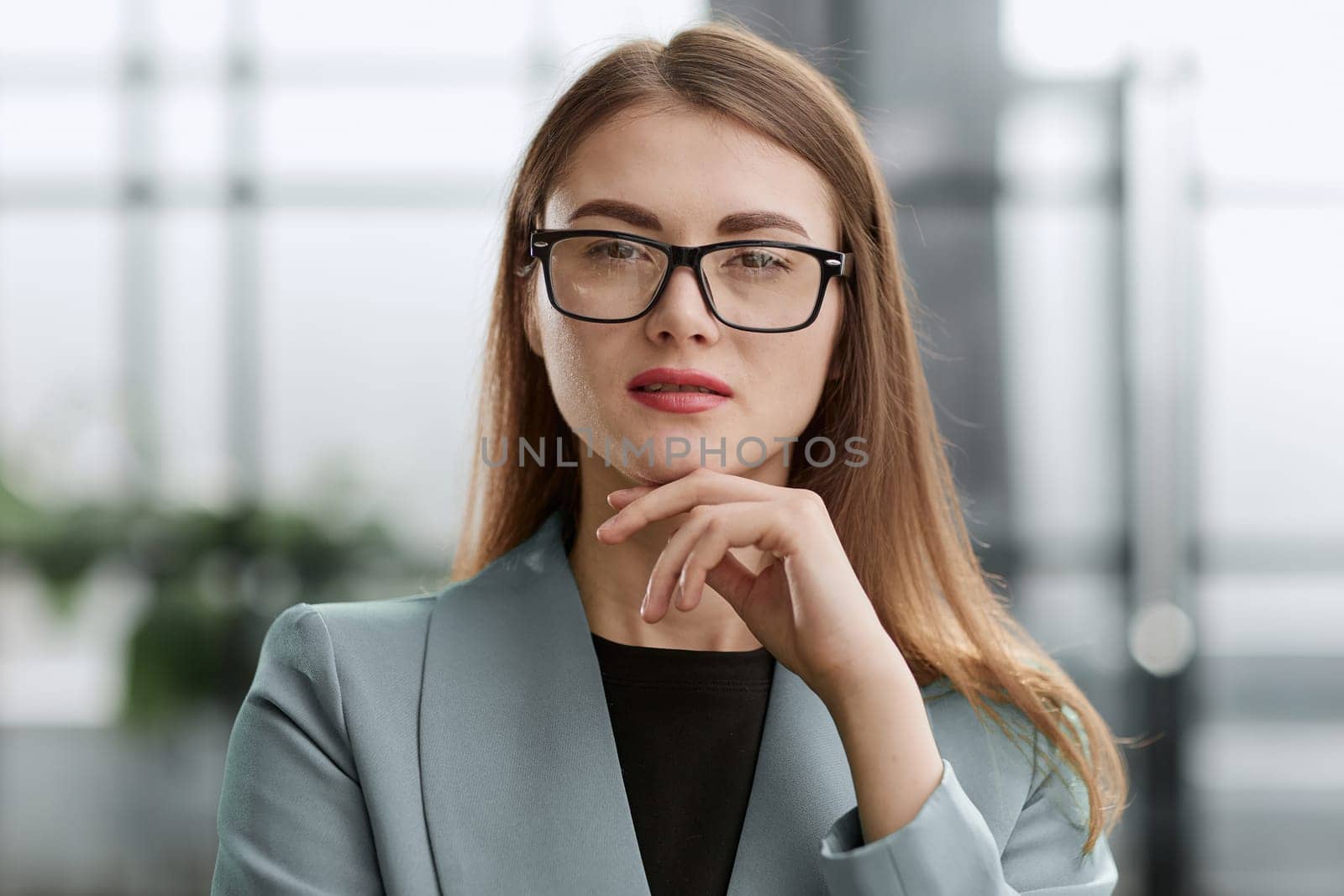 Portrait of a confident young businesswoman standing with her arms crossed in an office.