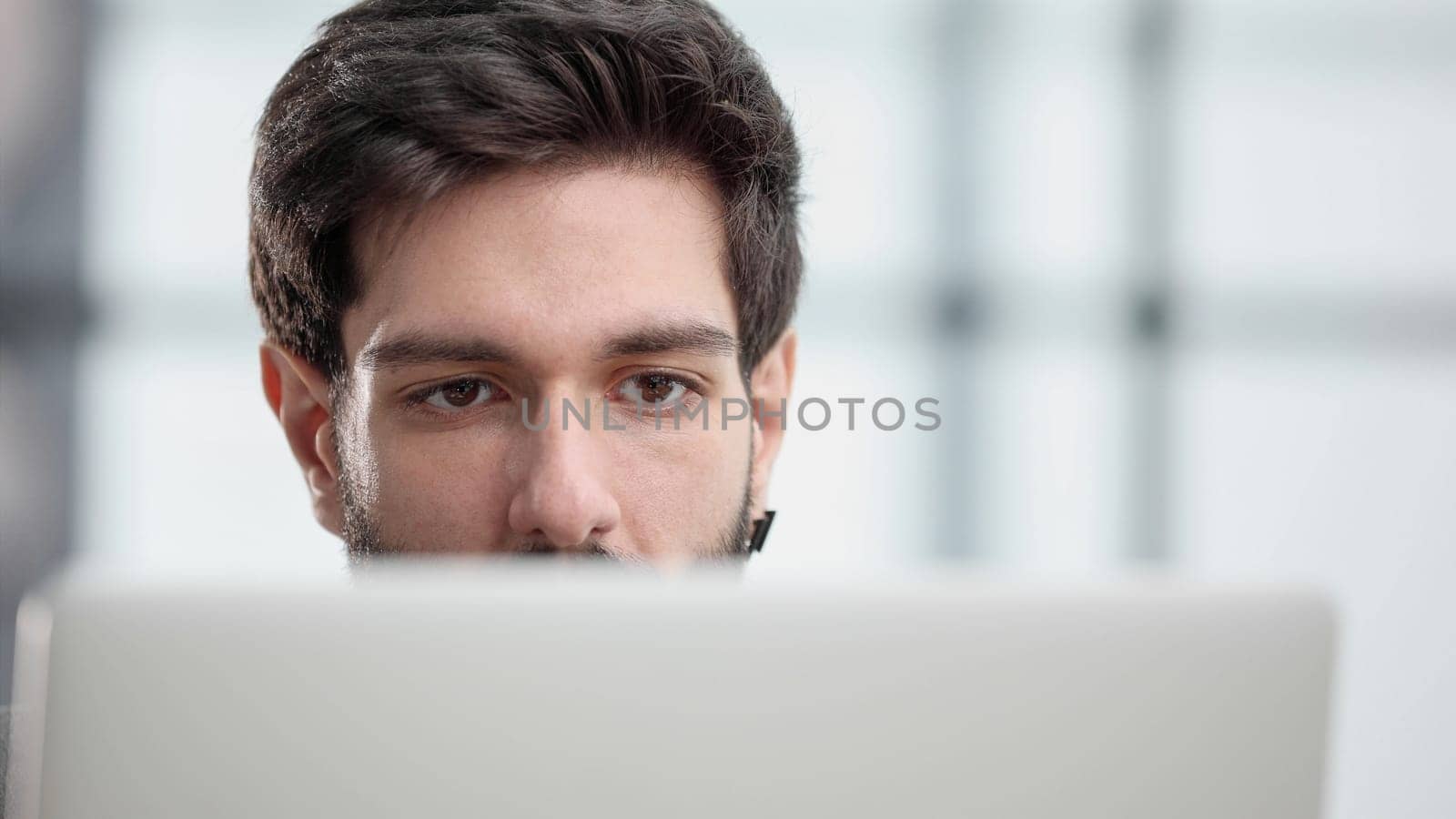 focused young businessman looking at computer monitor