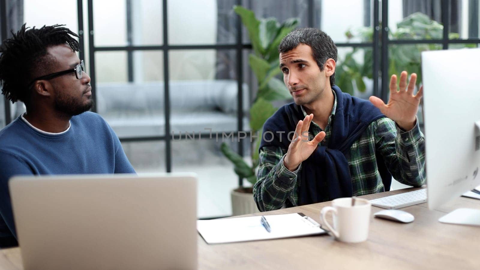 Business people working together in a modern trendy office behind a laptop