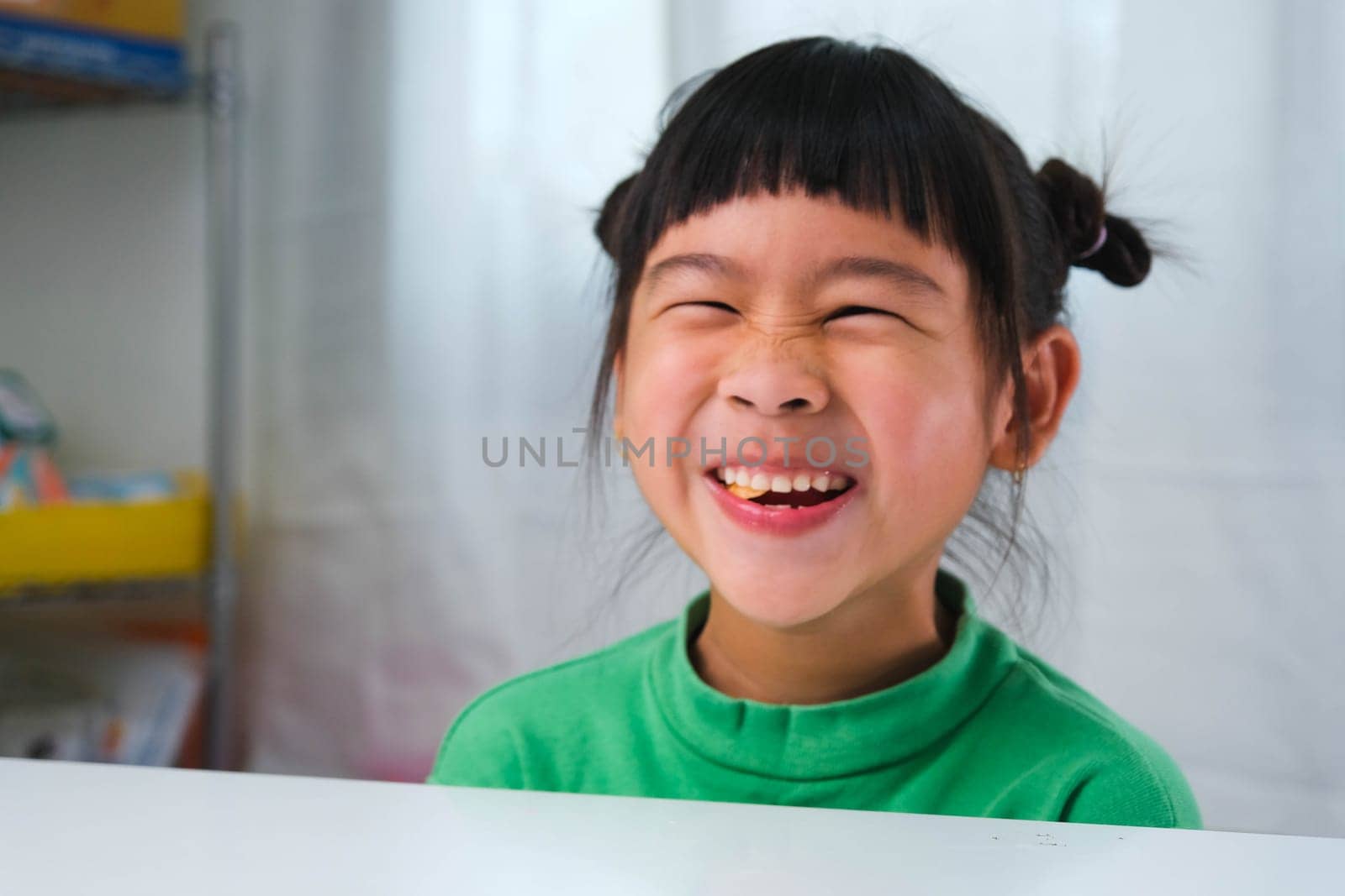 Happy cute little girl eating gelatin candy. Funny kid with chewing gum. Beautiful little girl with with vitamins for children like jelly candy.