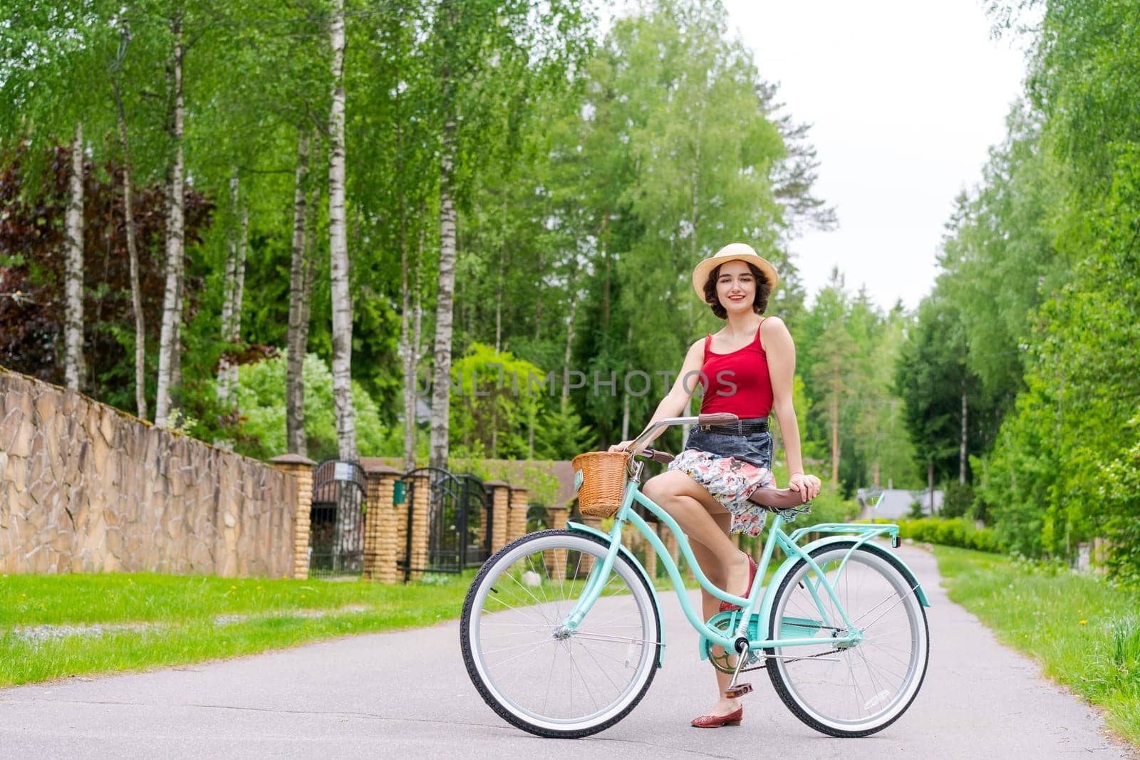 Portrait beautiful young girl in hat with bicycle on street in countryside by EkaterinaPereslavtseva