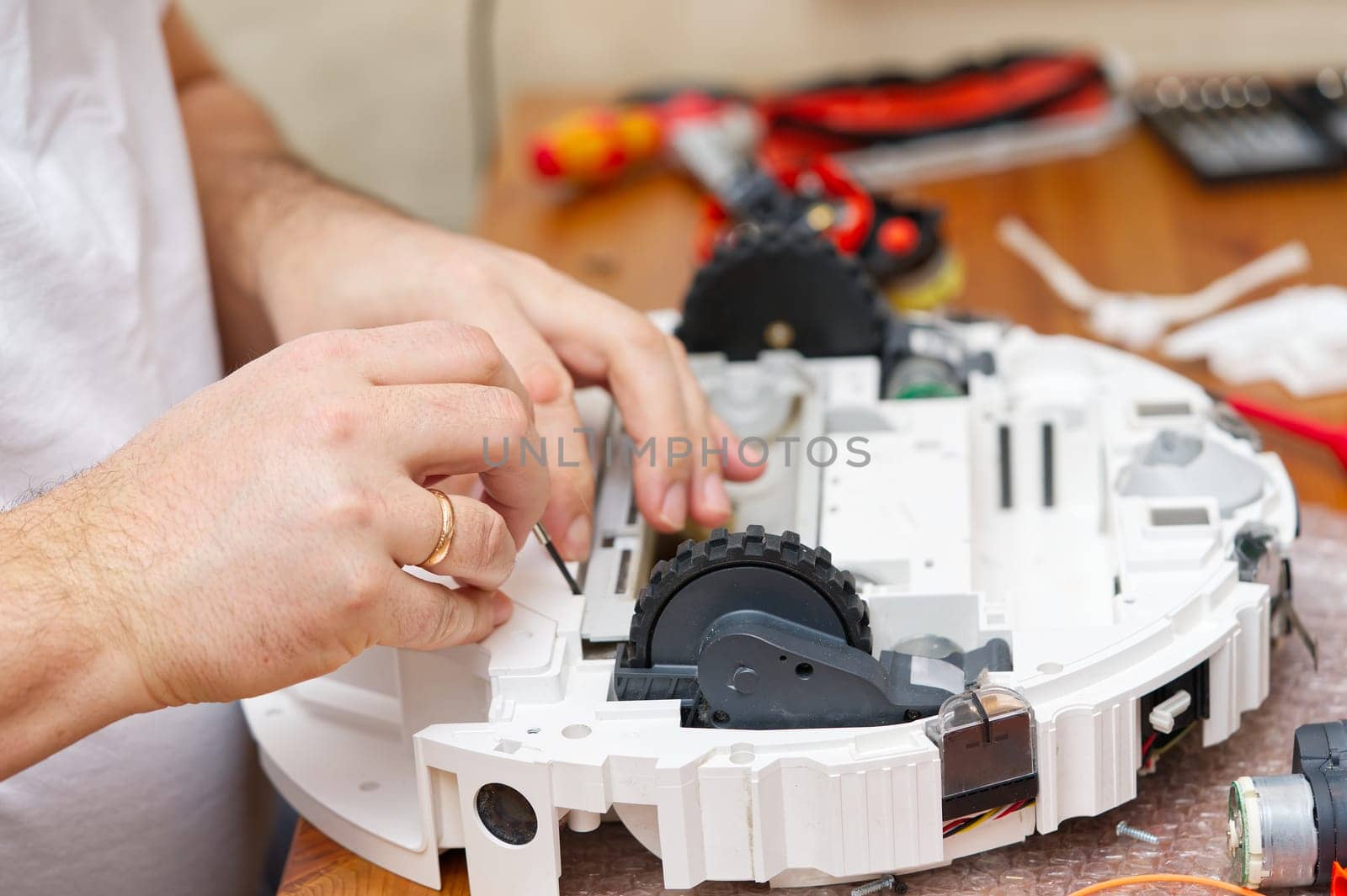 Repair of the robot vacuum cleaner. Disassembled robot vacuum cleaner. home electronics repair concept