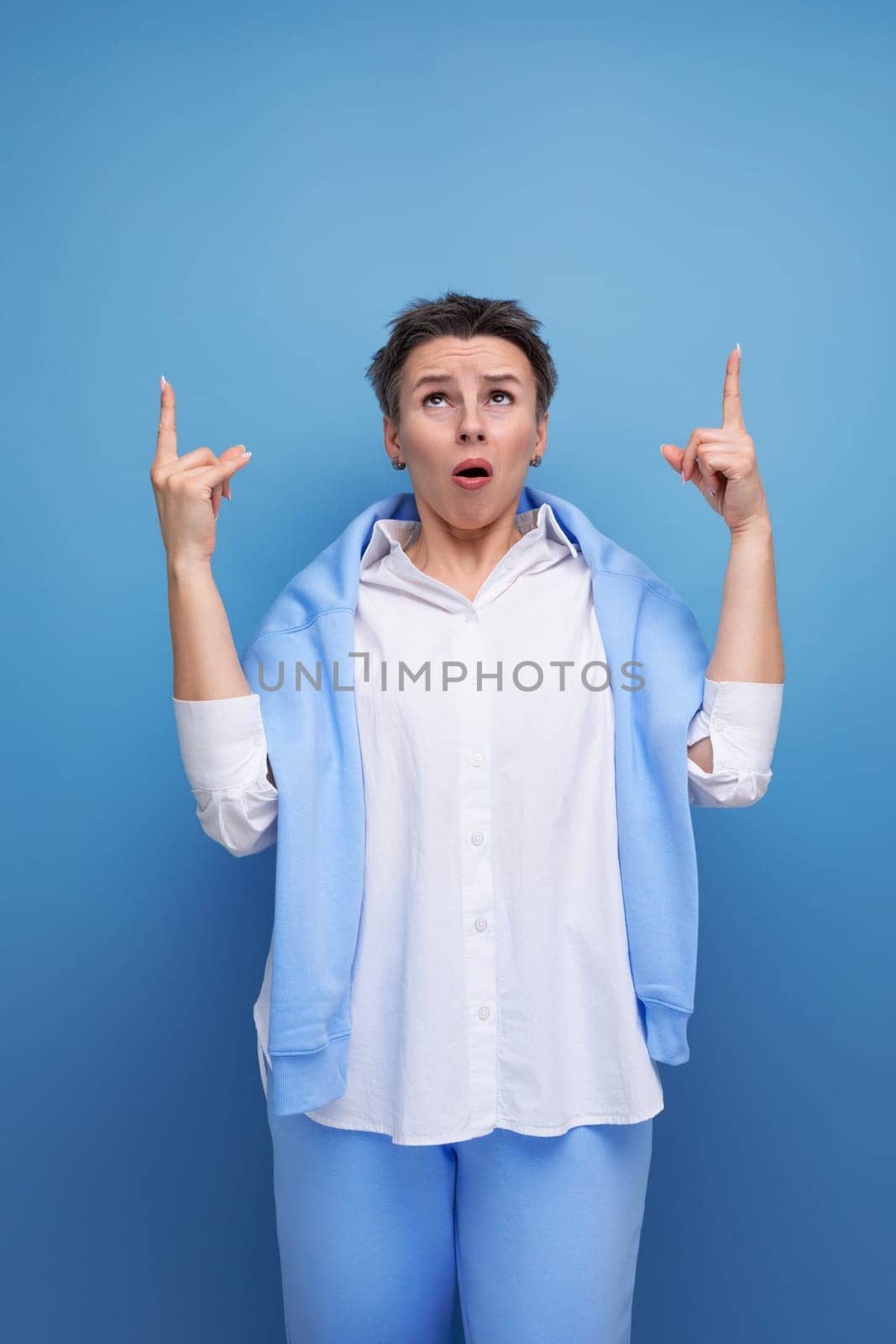 indignant young lady with short haircut in studio background.