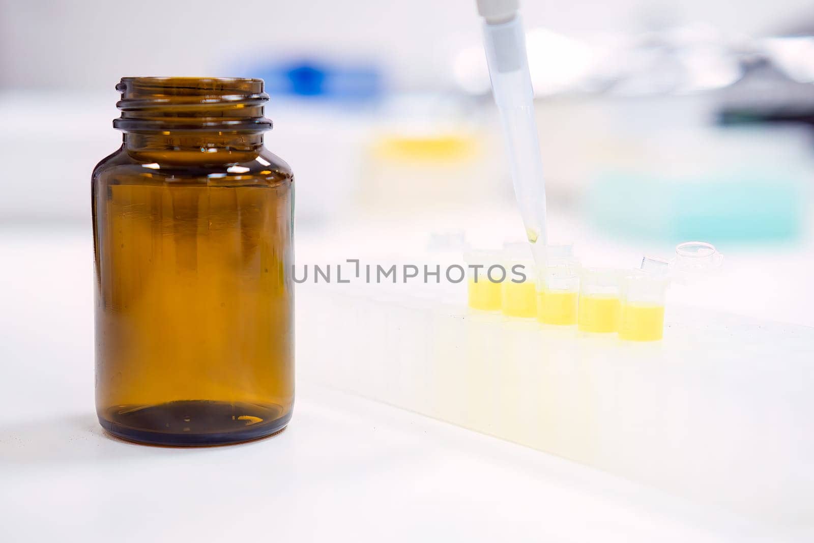 Chemical laboratory. Filling stock reagents with an automatic pipette.