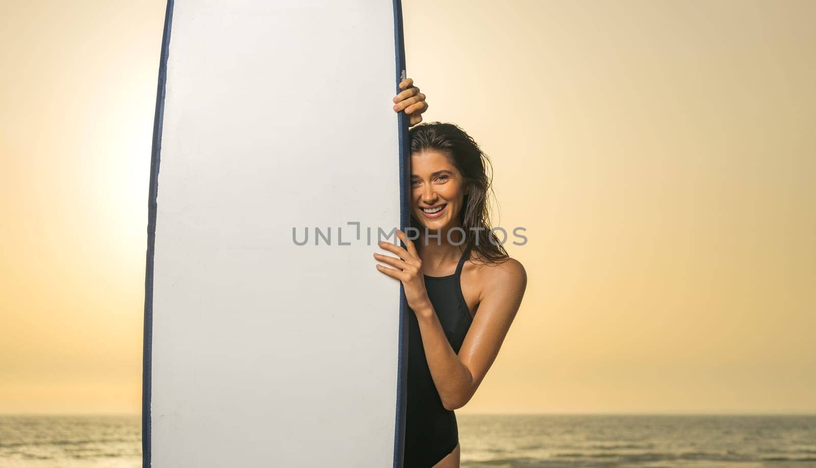 Girl surfer, vacation on Bali, Indonesia. Download a photo with copy space to advertise tours to a warm country. Surfing and vacation picture for social media promo. by MikeOrlov