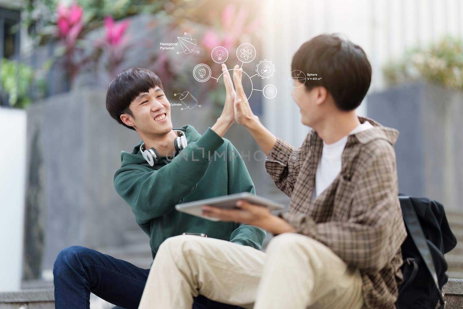 Young Asian male college student with friends at outdoors. College student playing game and celebrate on the college campus.