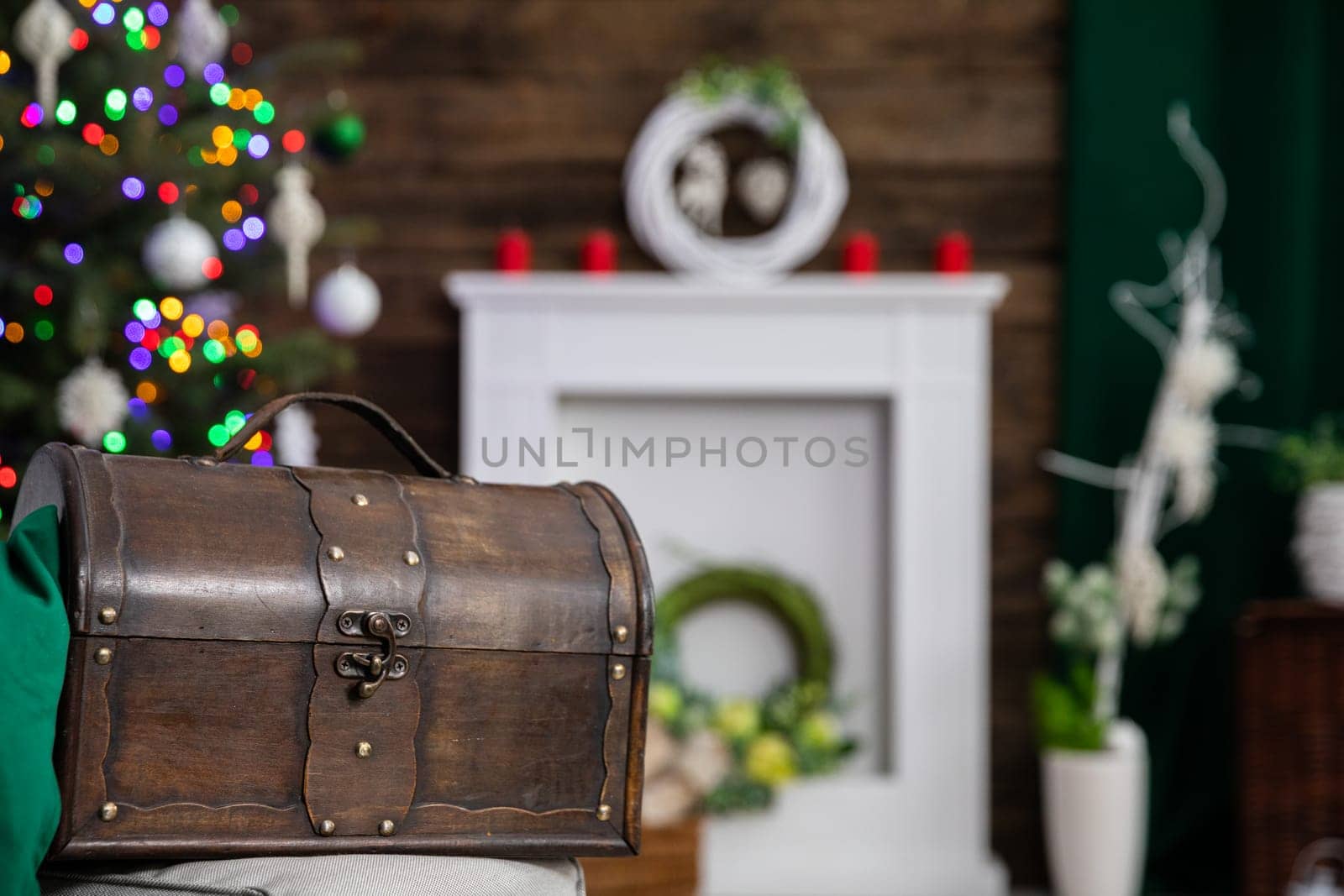 An old decorative wooden box in dark brown color stands as a decoration in the living room during Christmas.