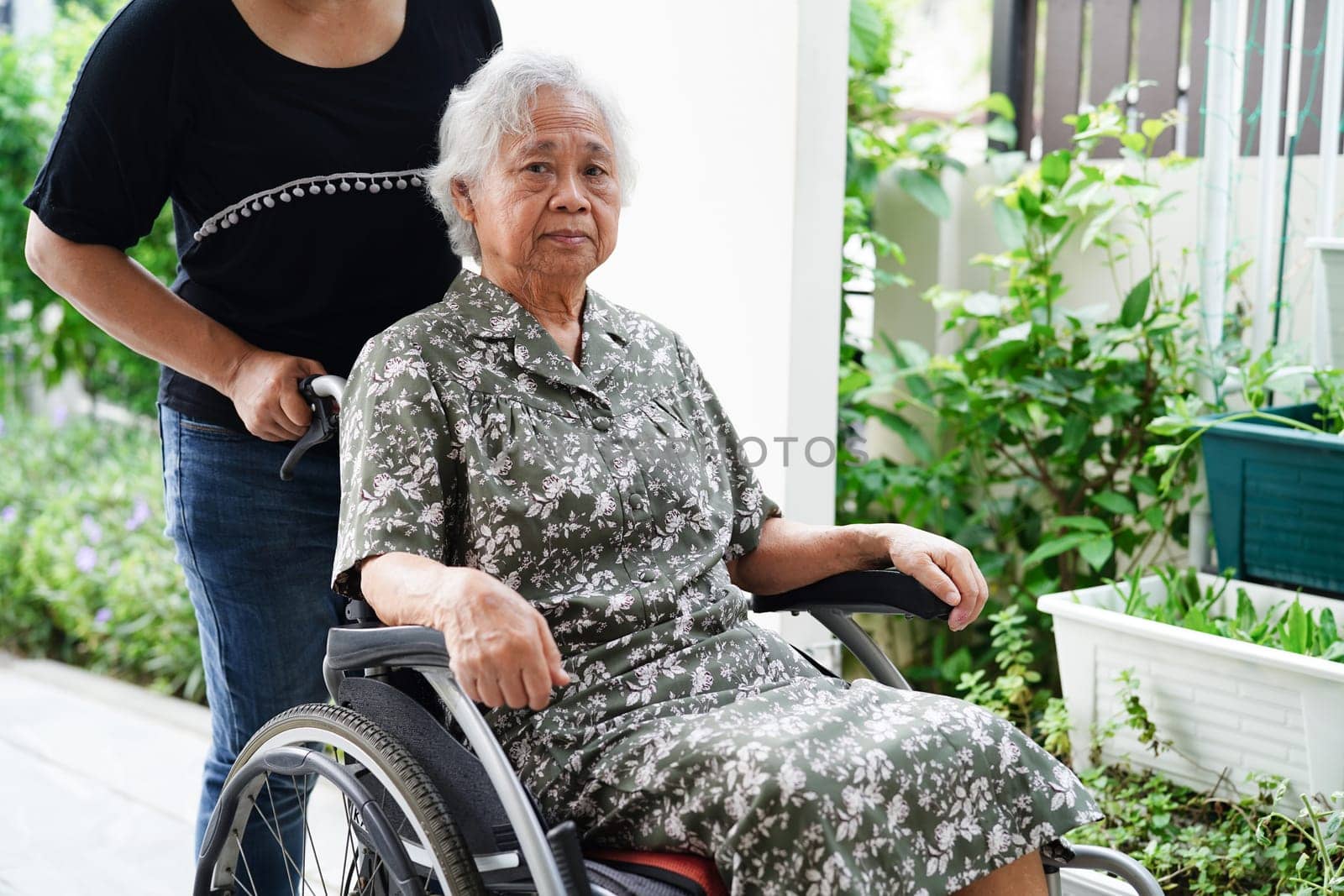 Doctor help Asian elderly woman disability patient sitting on wheelchair in hospital, medical concept.