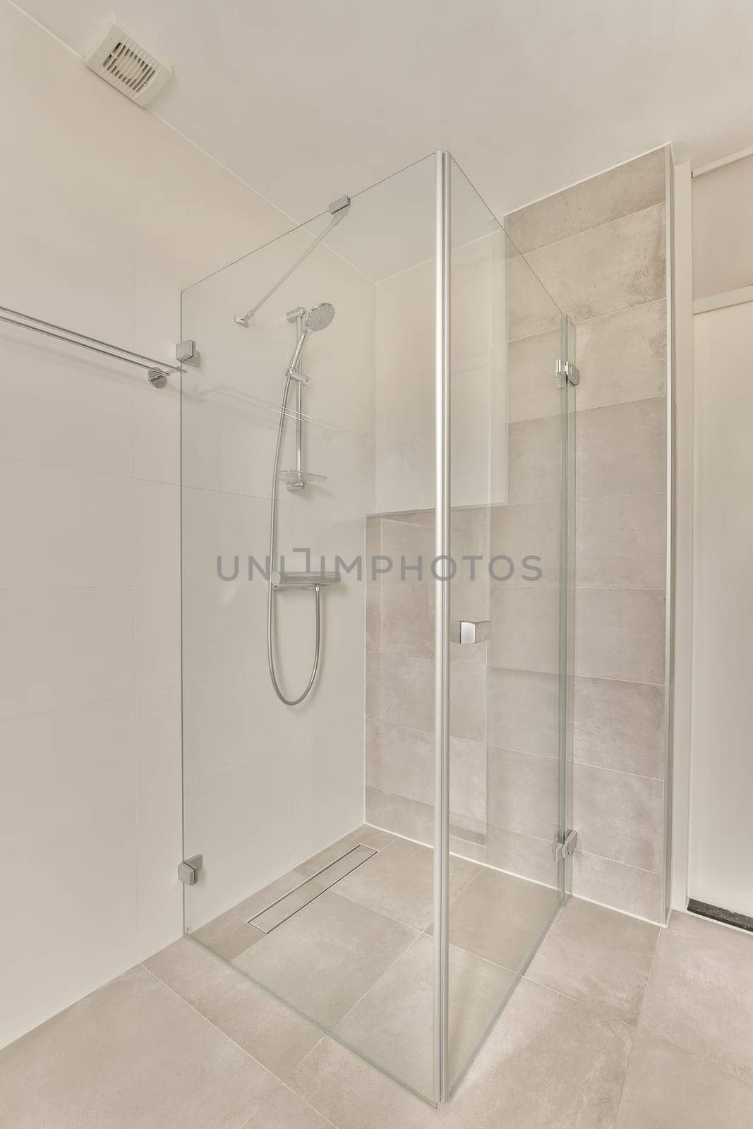 a bathroom with a glass shower door and white tiles on the floor, along with a walk - in shower stall