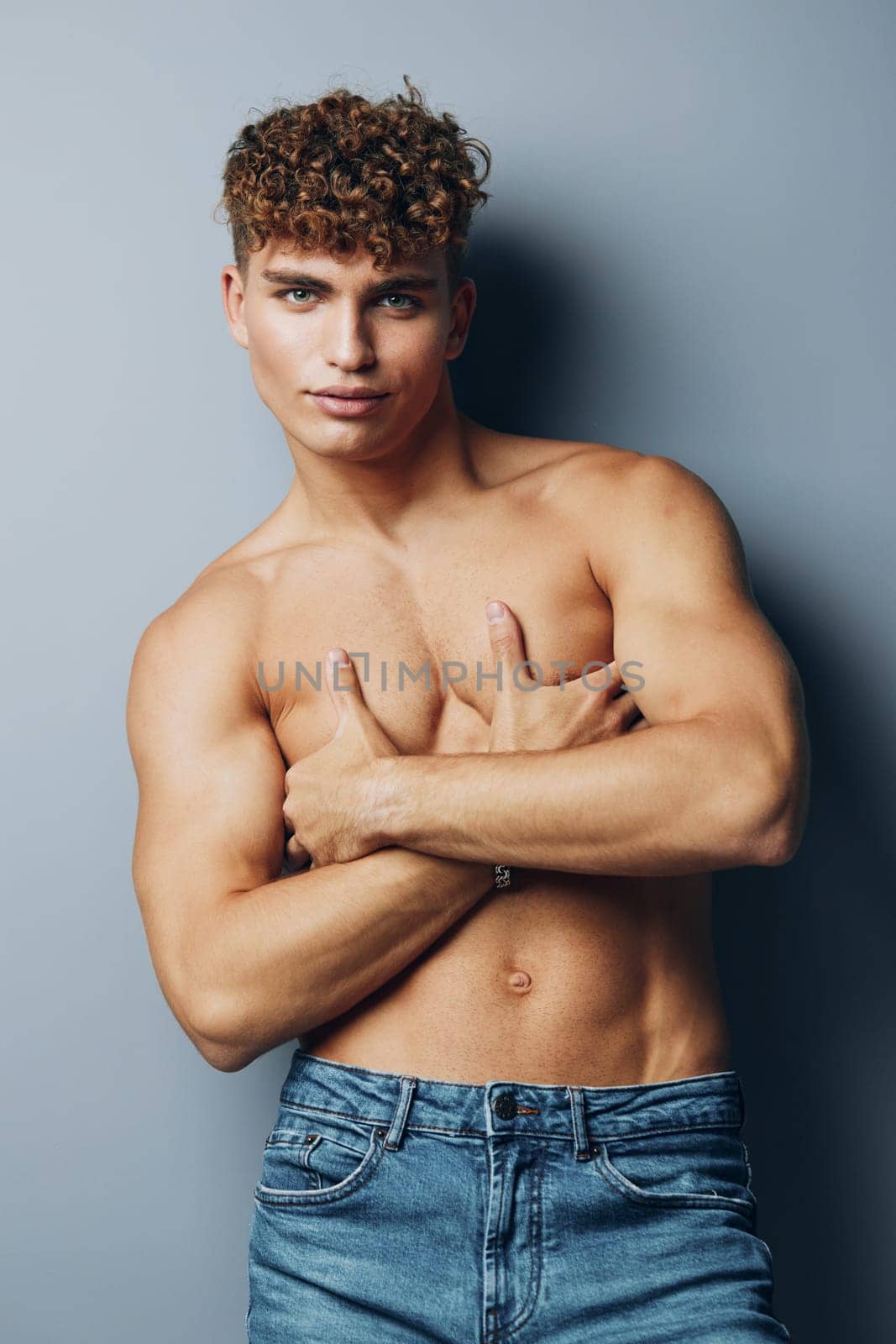 man studio male fitness lifestyle muscle gray bicep jeans shirtless by SHOTPRIME