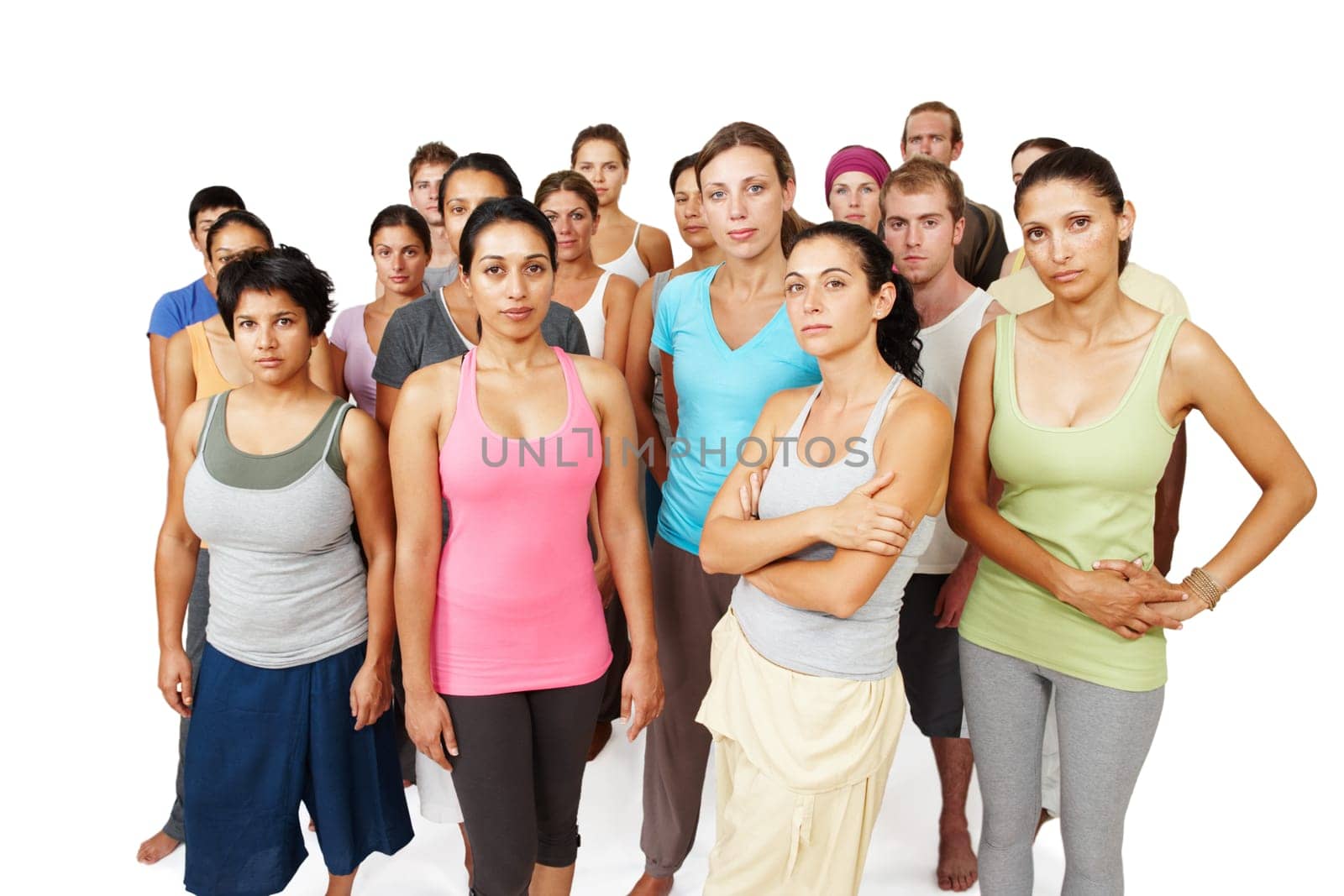 Theyre serious about yoga fitness. A serious and focused yoga class standing together on a white background