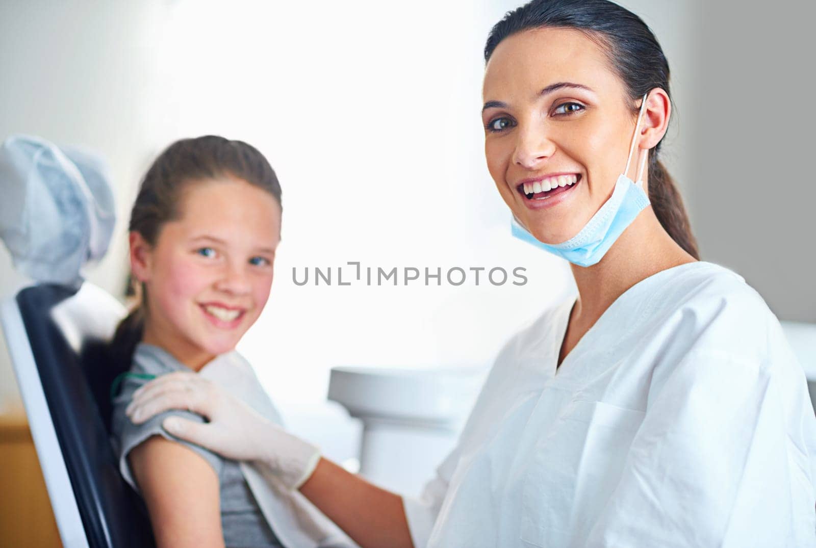 Another perfect smile comes through my office. Portrait of a female dentist and child in a dentist office