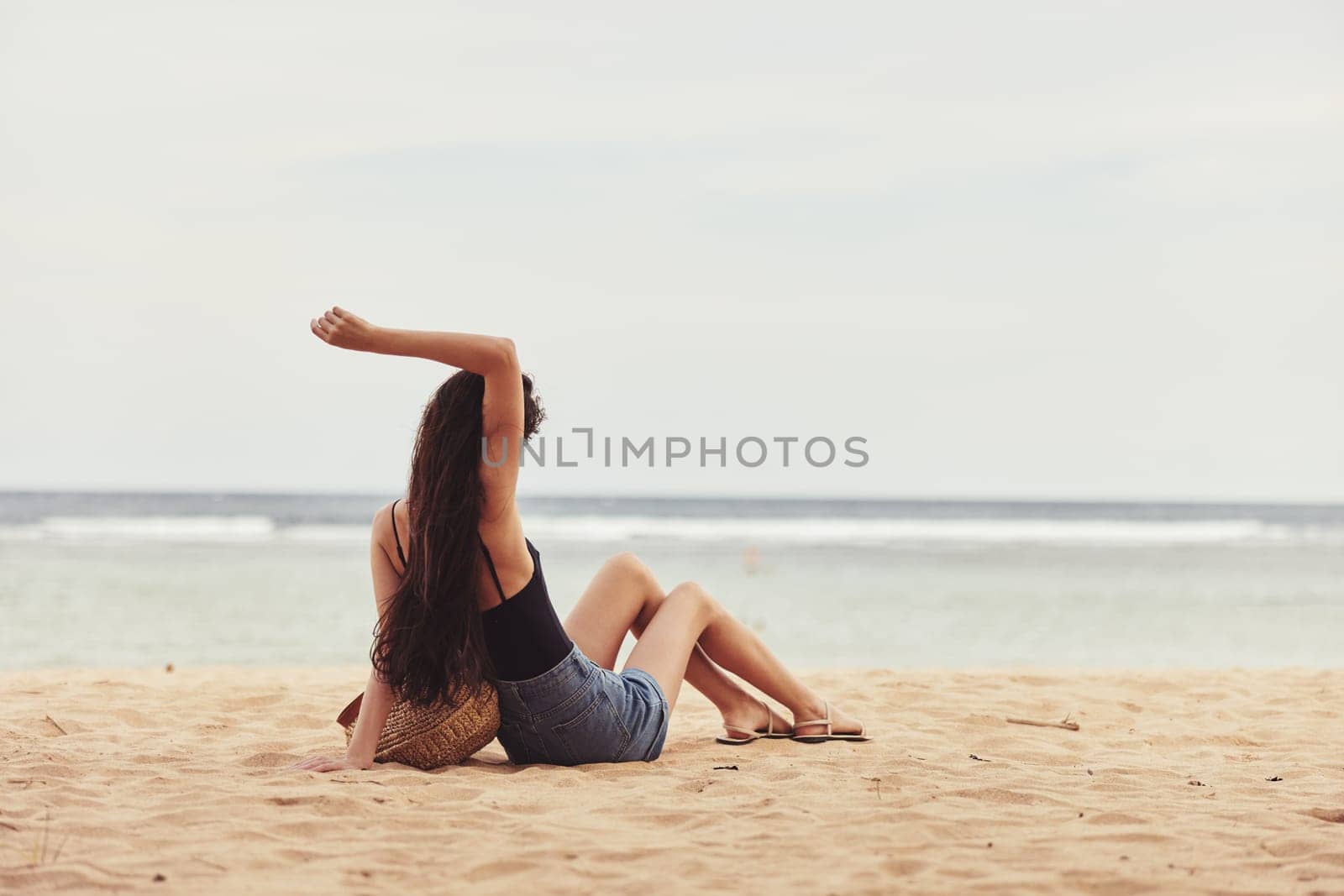 hair woman summer girl travel freedom vacation carefree long sitting alone sand smile sea beach body young fashion coast hair nature relax